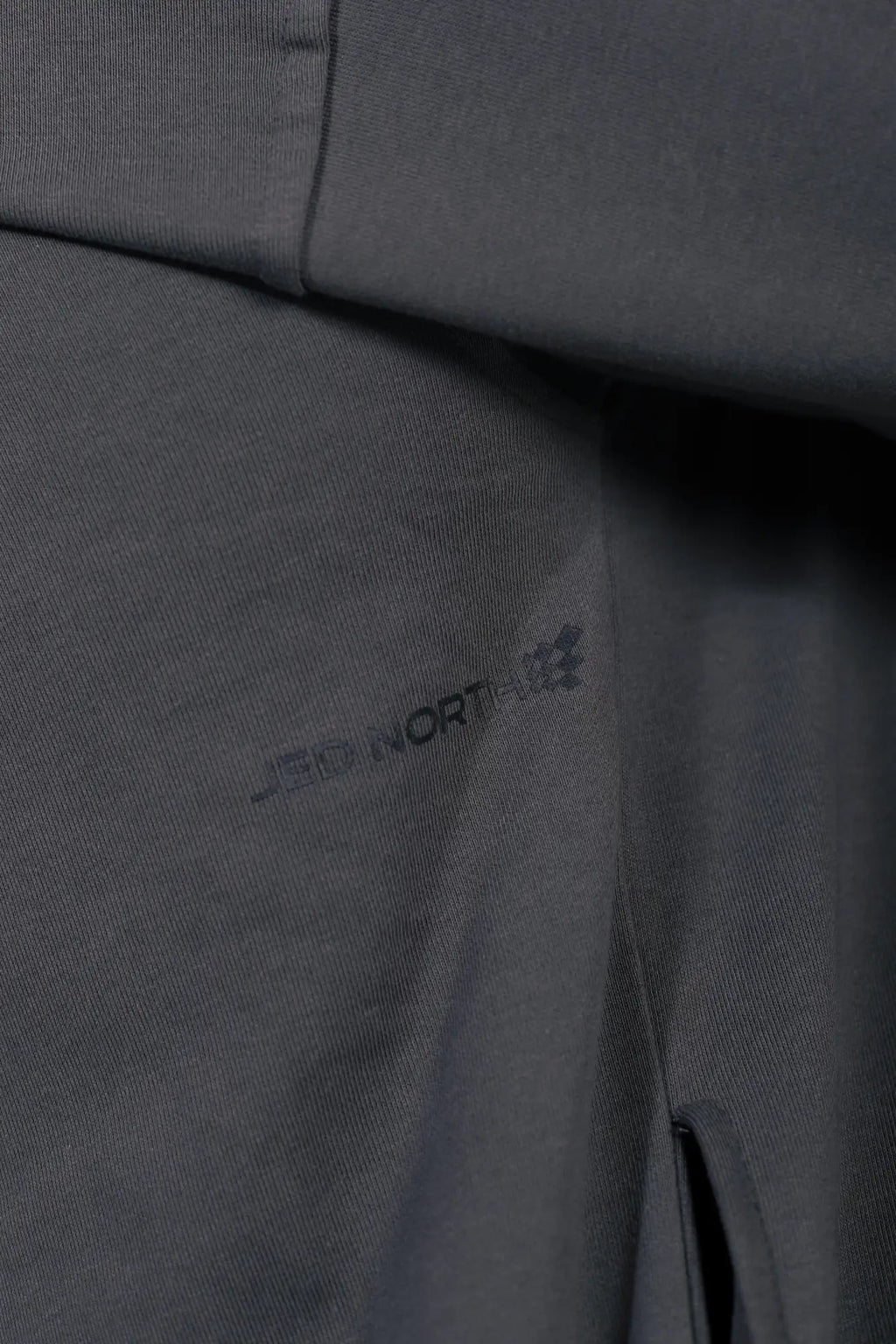 Dark gray jed north essentials relaxed hoodie with subtle textured weave and mountain hardwear logo embroidery