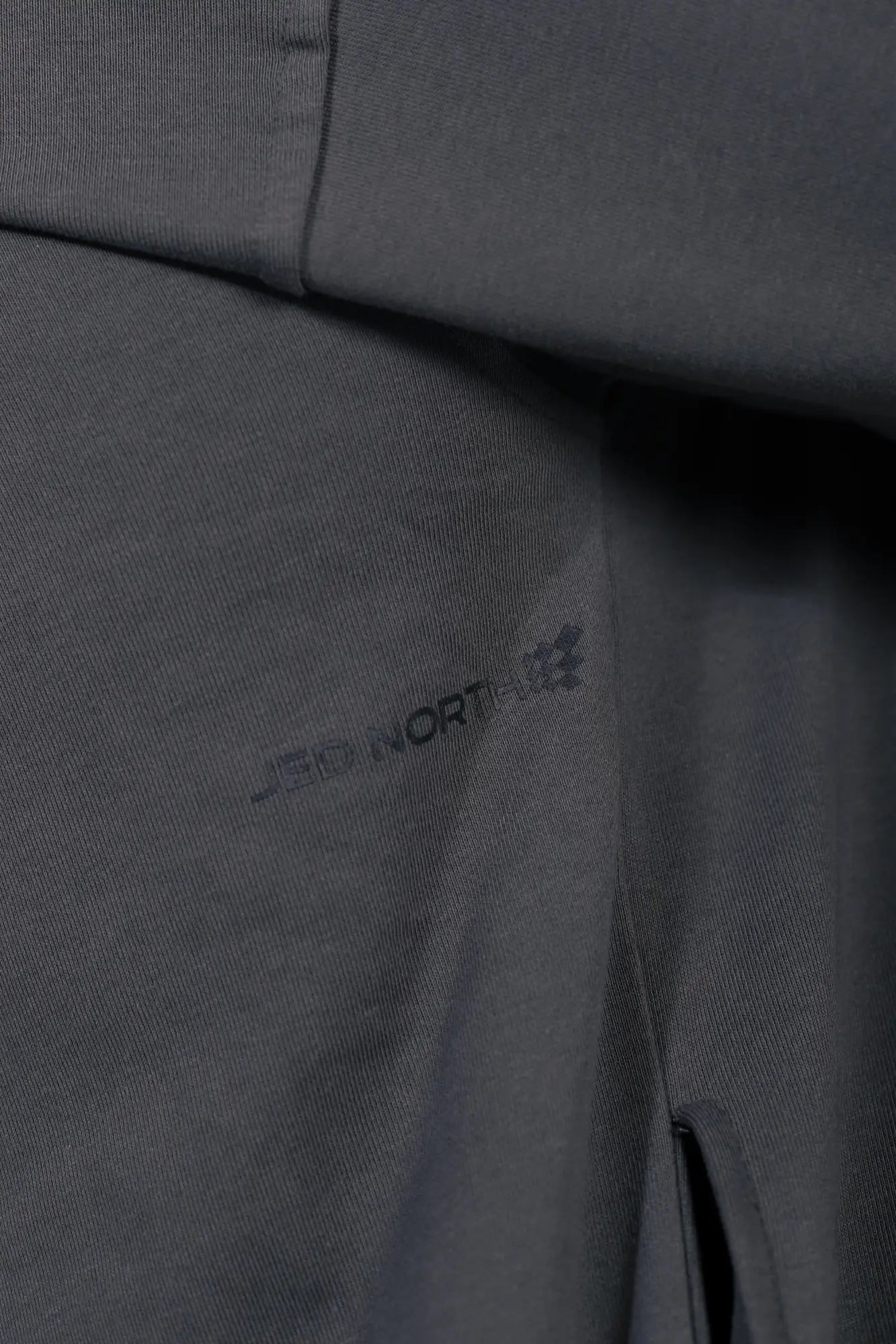 Dark gray jed north essentials relaxed hoodie with subtle textured weave and mountain hardwear logo embroidery