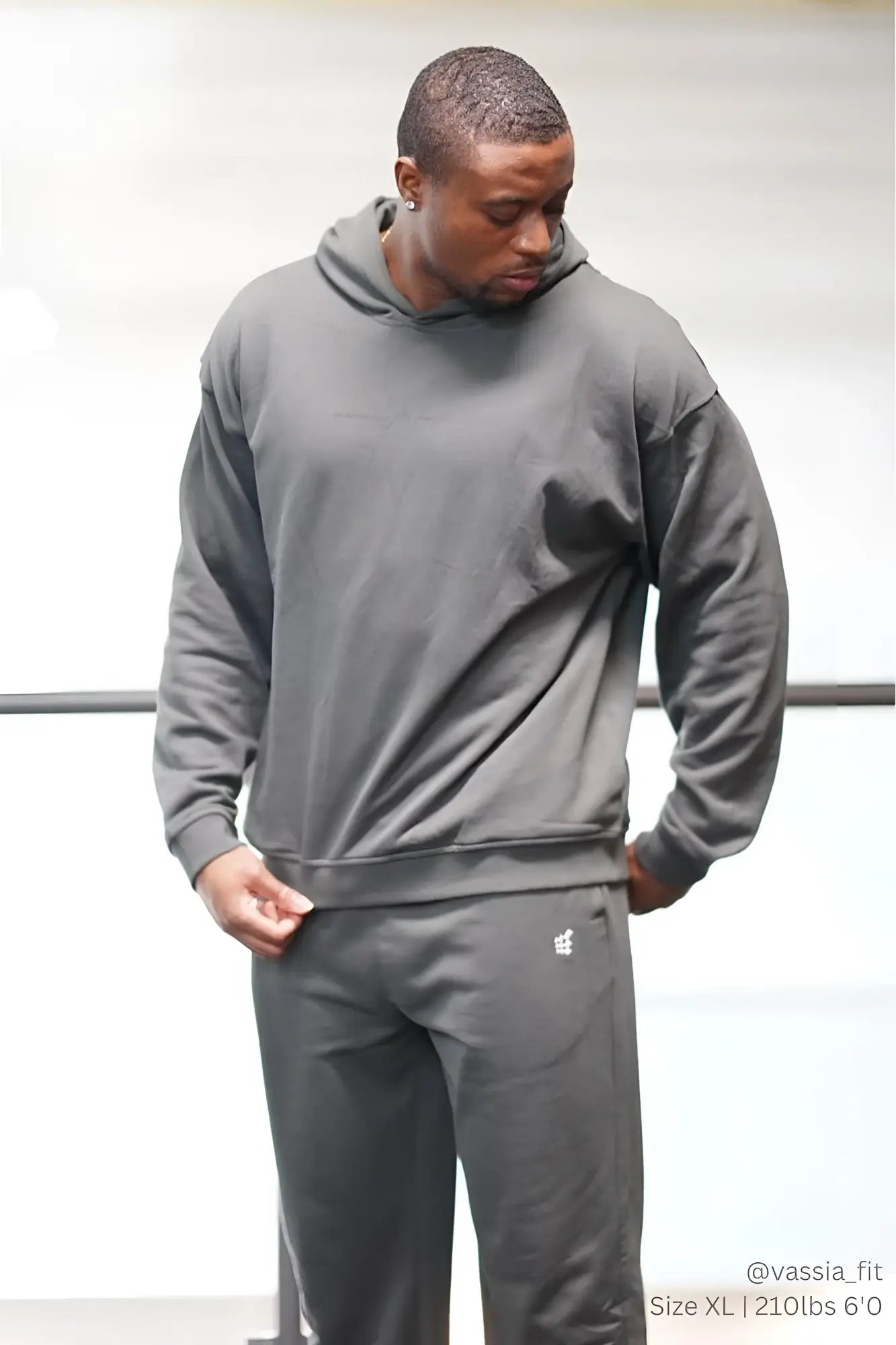 Gray hooded sweatshirt and matching pants with subtle white logo on lower left leg by Jed North Essentials