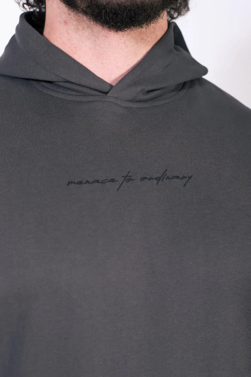 Dark gray jed north essentials relaxed hoodie with a subtle embroidered phrase across the chest