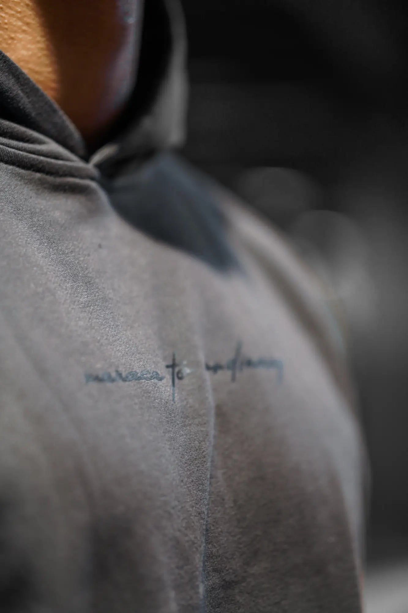 Jed North Essentials relaxed hoodie in dark gray with textured fabric and embroidered cursive lettering on the chest