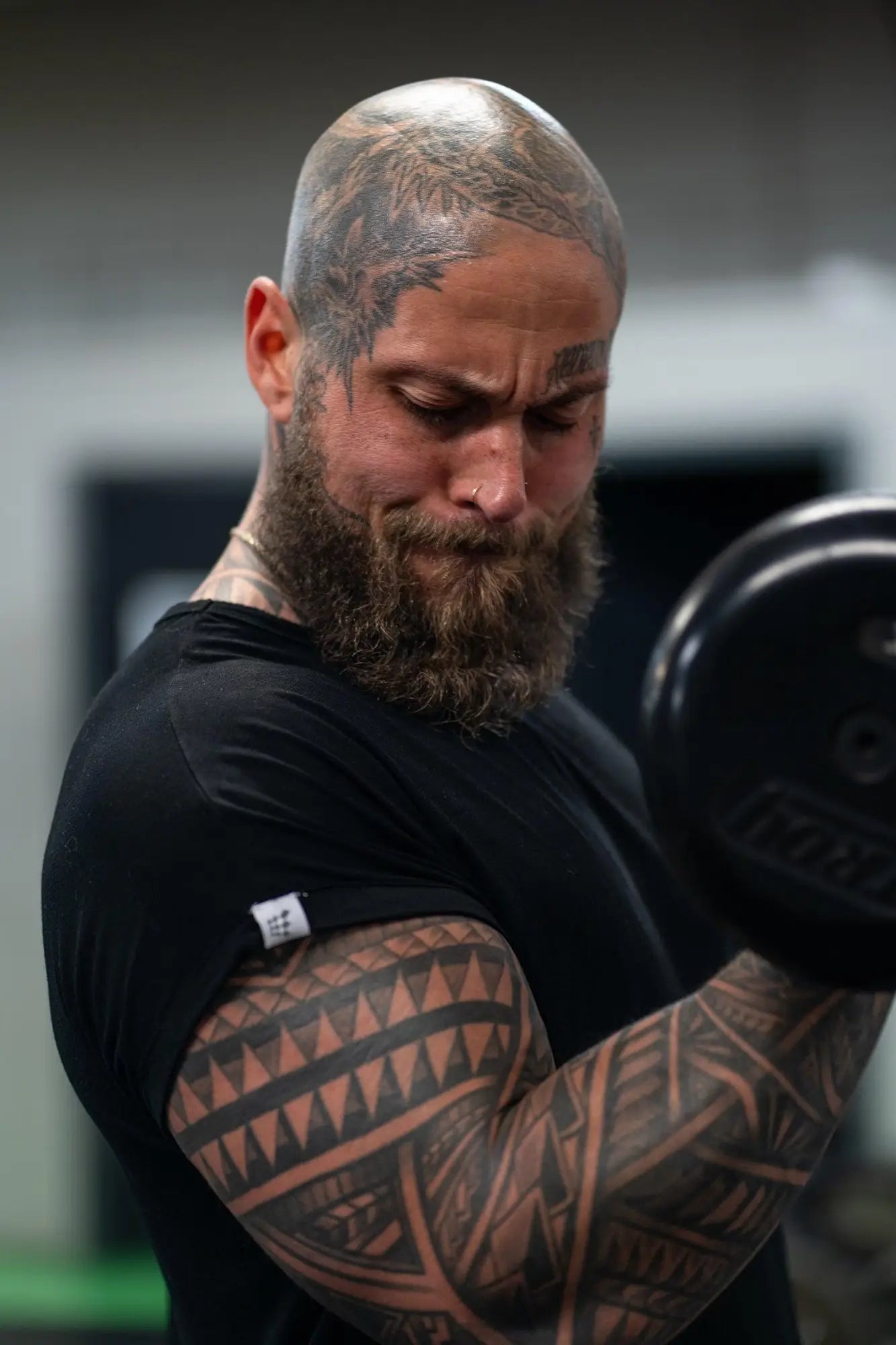 Jed North Evolve cap sleeve muscle t-shirt 2.0 black with a black matte finish weightlifting barbell visible