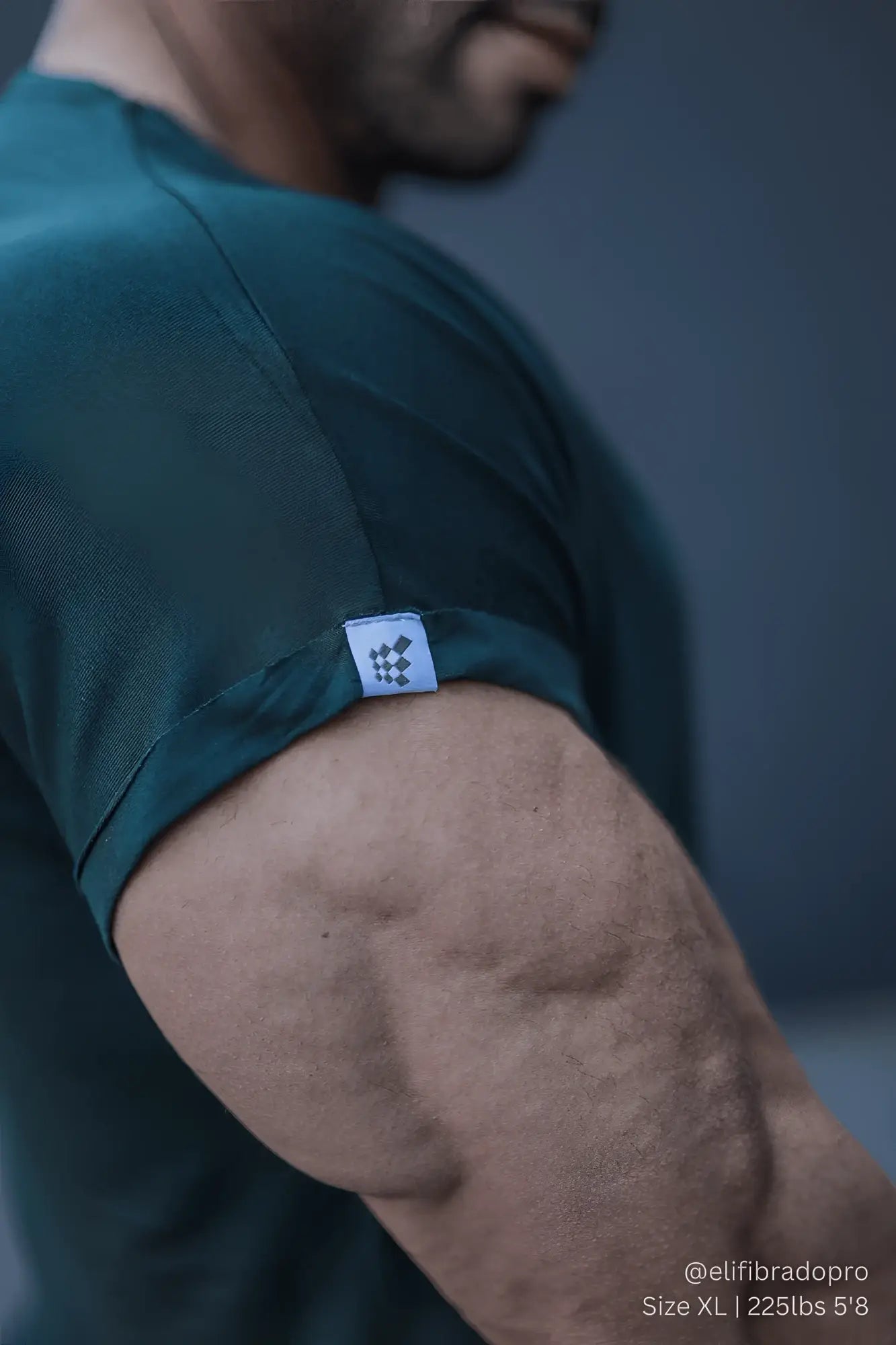 Dark green jed north evolve men’s cap sleeve t-shirt 2.0 with small white brand tag on sleeve for athletic use