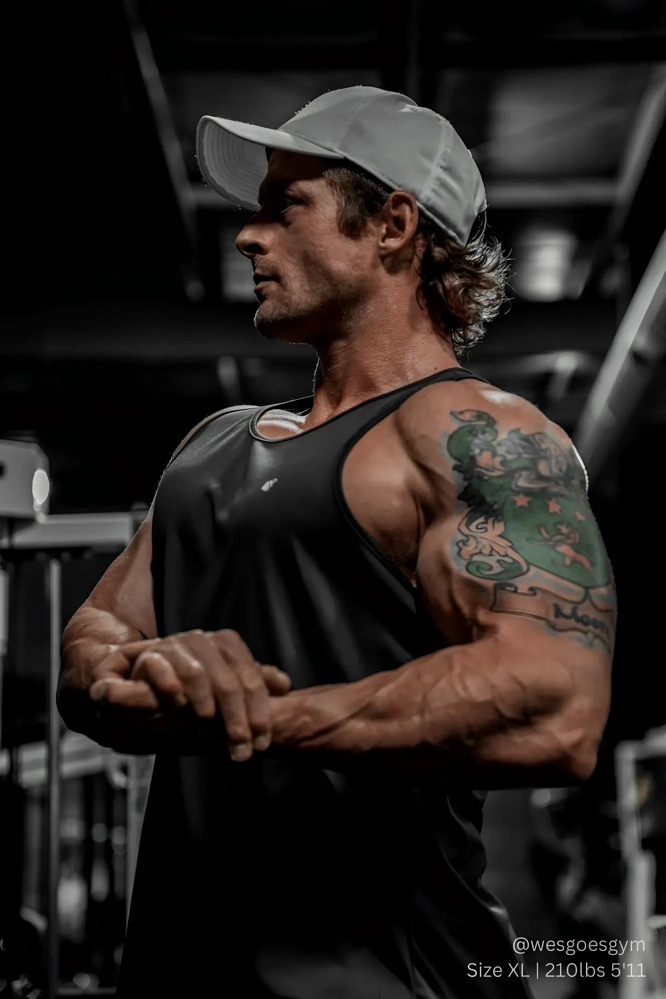 Gray baseball cap with subtle logo front paired with jed north black fast-dry bodybuilding workout stringer