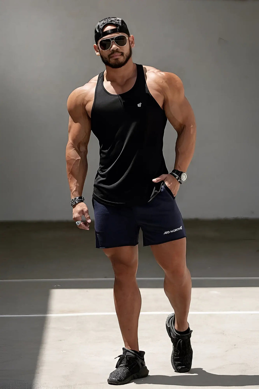 Black sleeveless jed north fast-dry bodybuilding workout stringer with small white logo on the chest