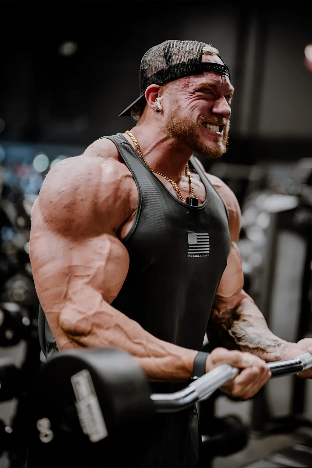 Black fast-dry bodybuilding workout stringer tank top with small American flag logo on the chest