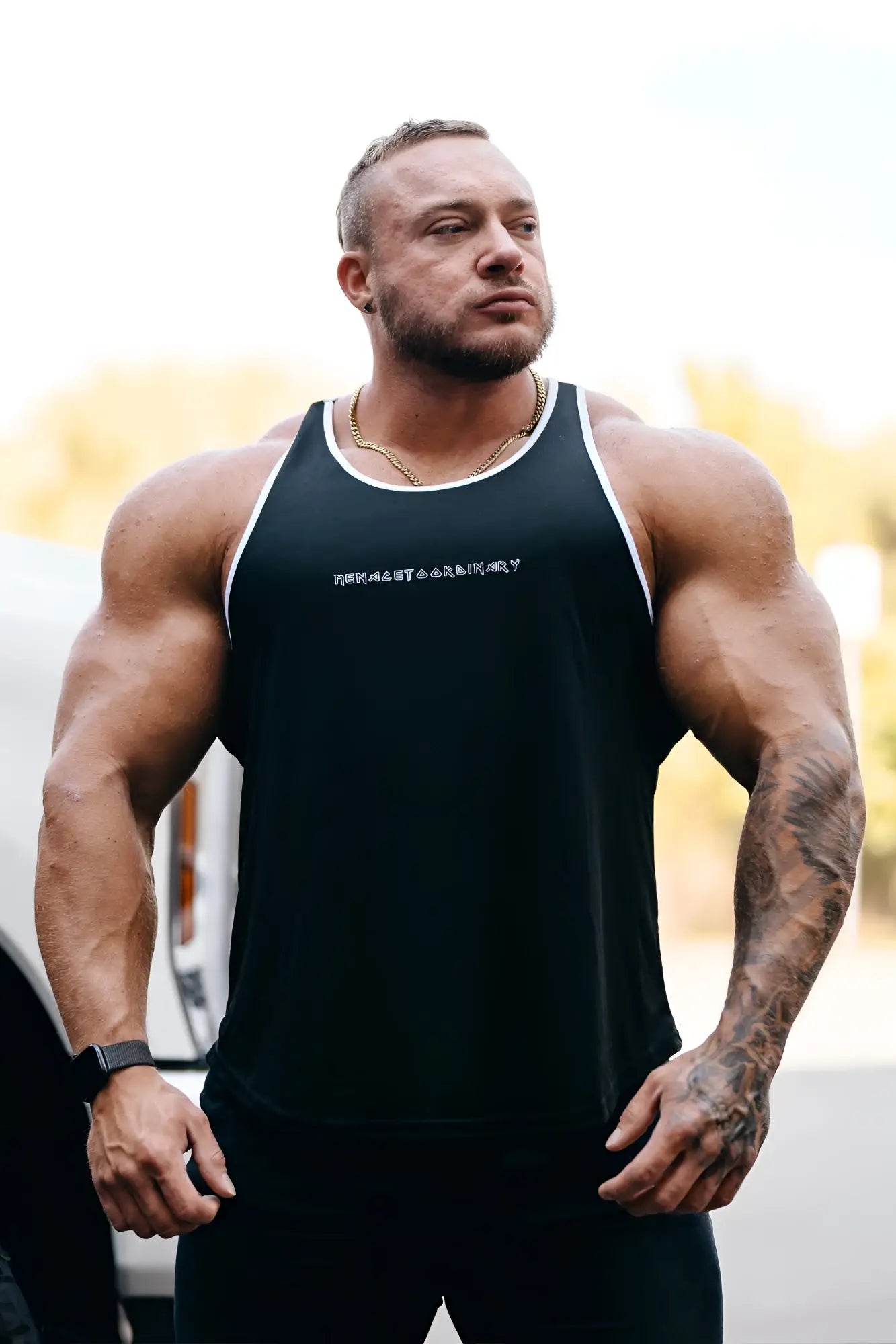 Black fast-dry bodybuilding workout stringer tank top with white trim and subtle embroidered chest logo
