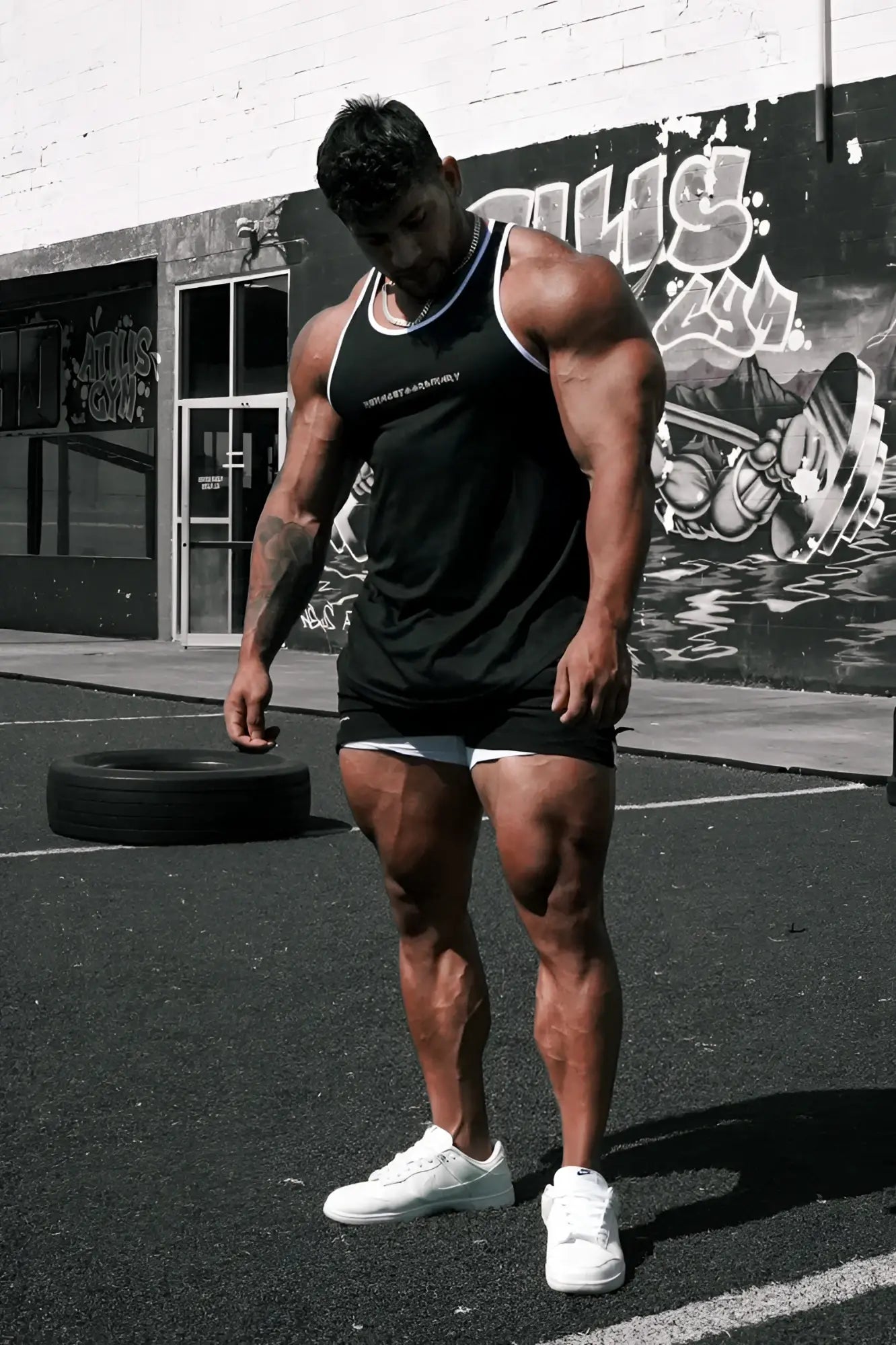 Black sleeveless fast-dry bodybuilding workout stringer tank top with white trim and small chest logo