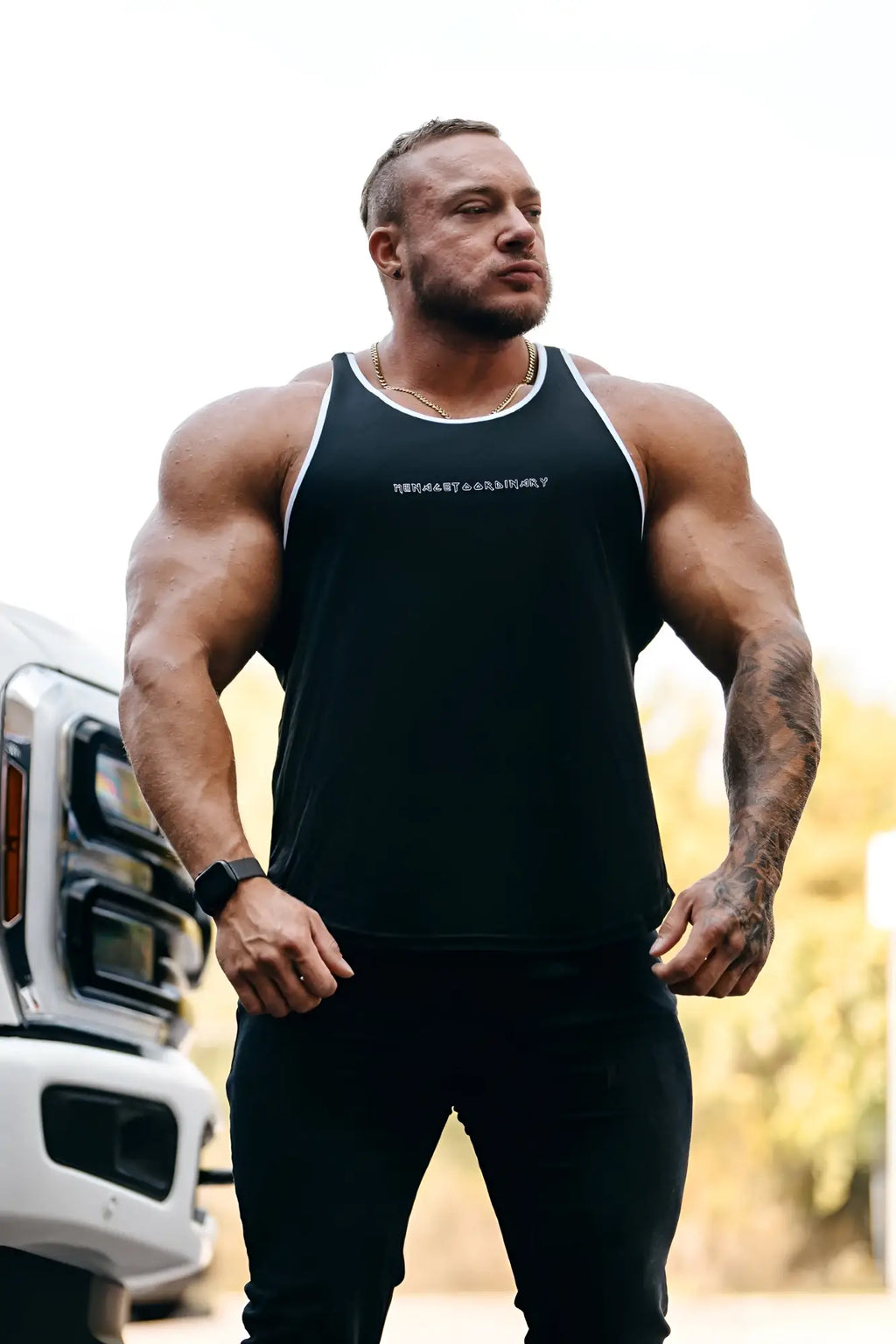 Black fast-dry bodybuilding workout stringer tank top with white trim and subtle chest embroidery