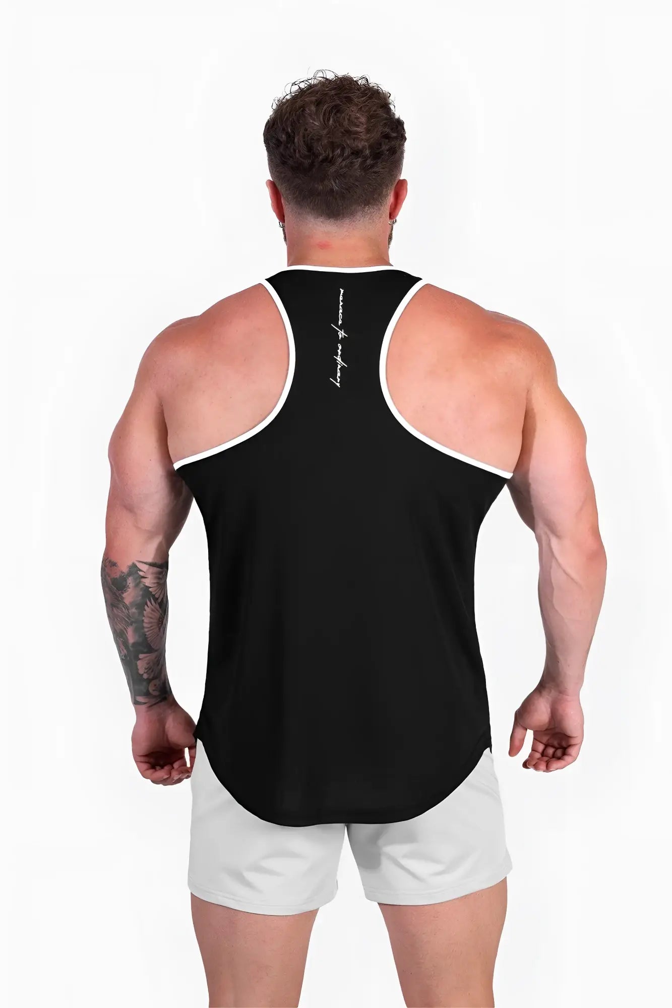 Back view of jed north fast-dry bodybuilding workout stringer tank top in black with white trim and vertical script logo