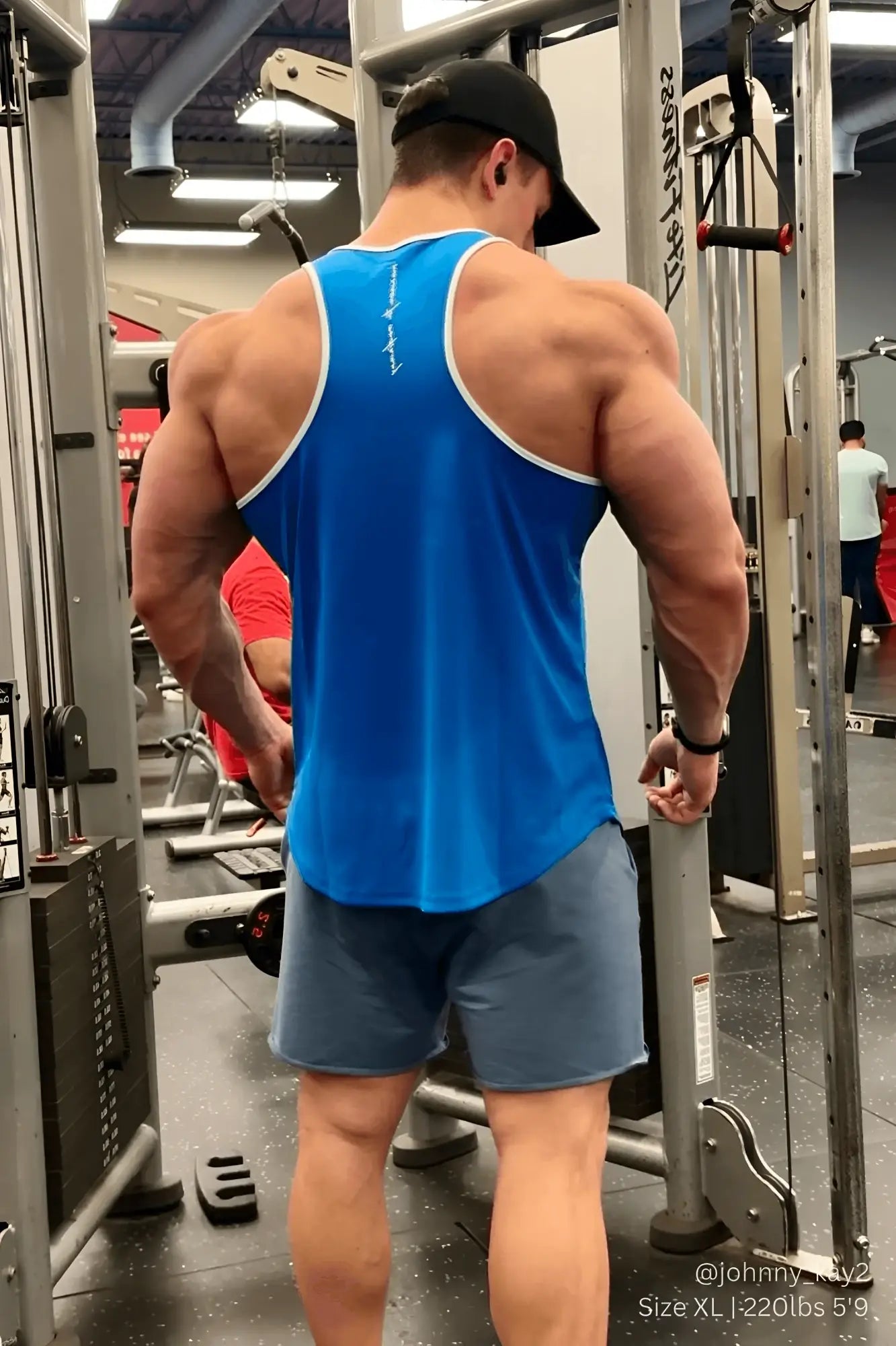 Back view of jed north fast-dry bodybuilding workout stringer tank top in blue with white trim and logo