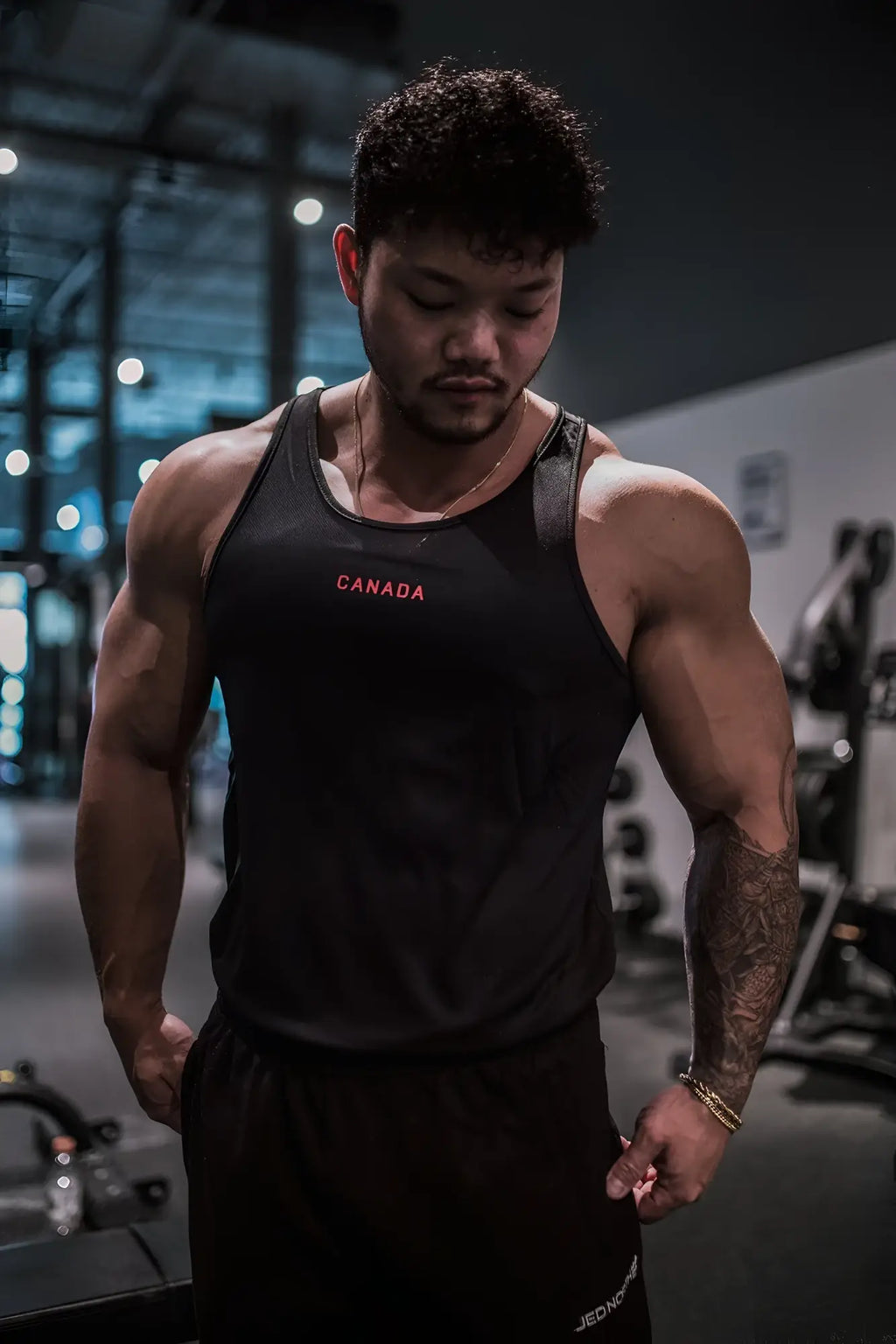 Black fast-dry bodybuilding workout stringer tank top with canada embroidered in red across the chest