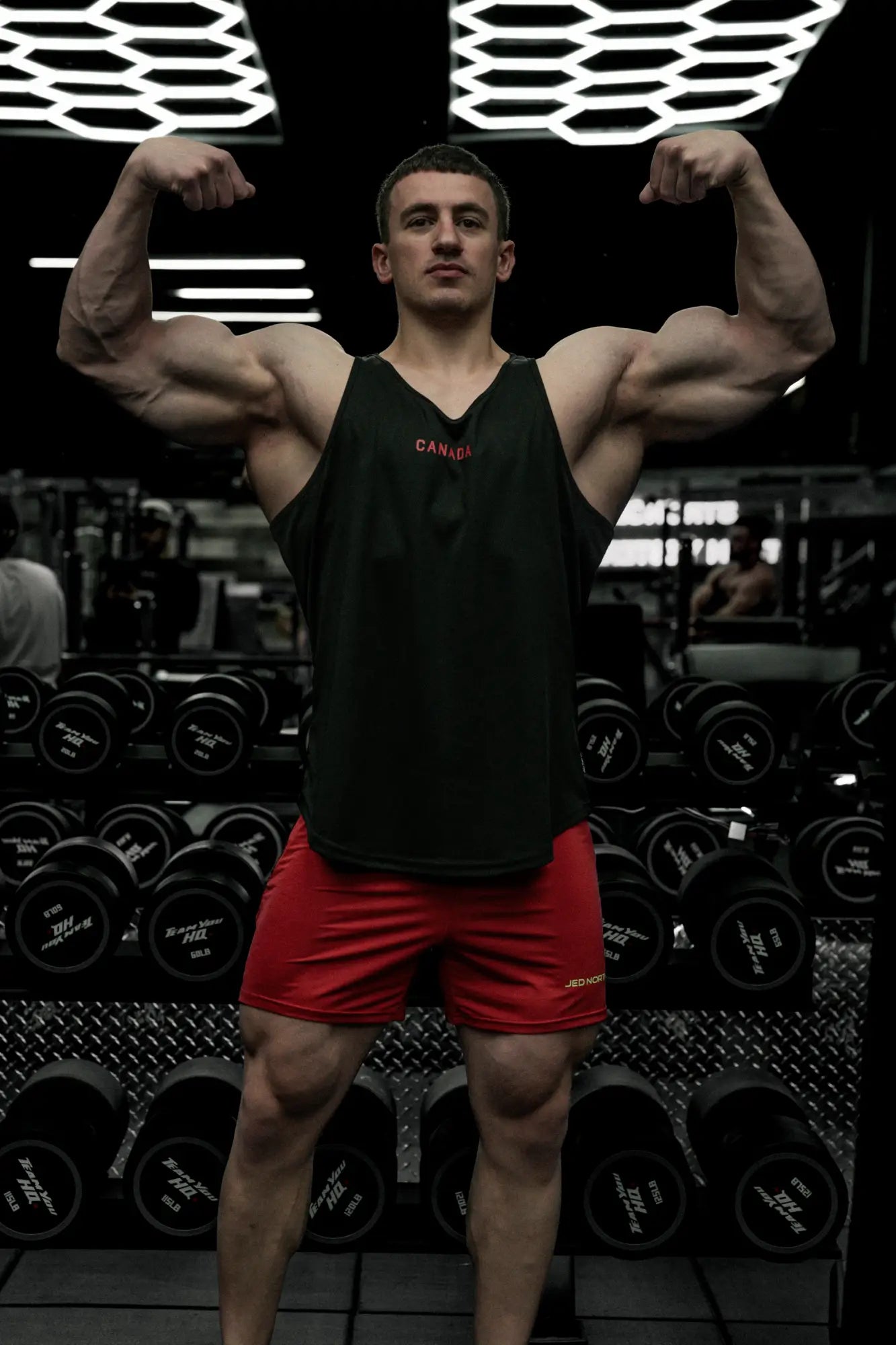 Fast-dry black bodybuilding workout stringer tank top with red canada print for active training and gym use