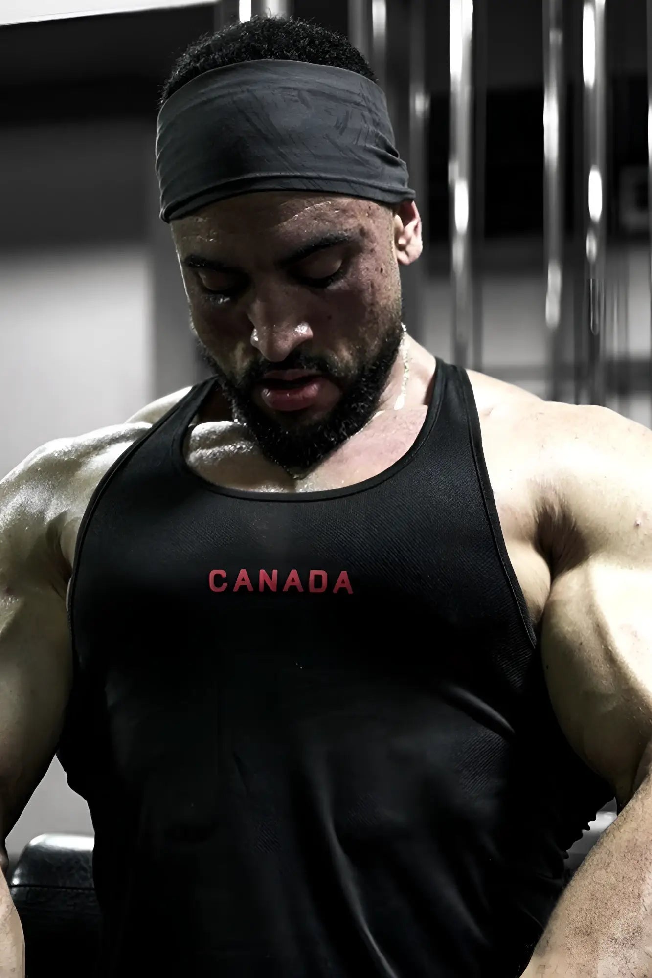 Black fast-dry bodybuilding workout stringer tank top with canada printed in red across the chest