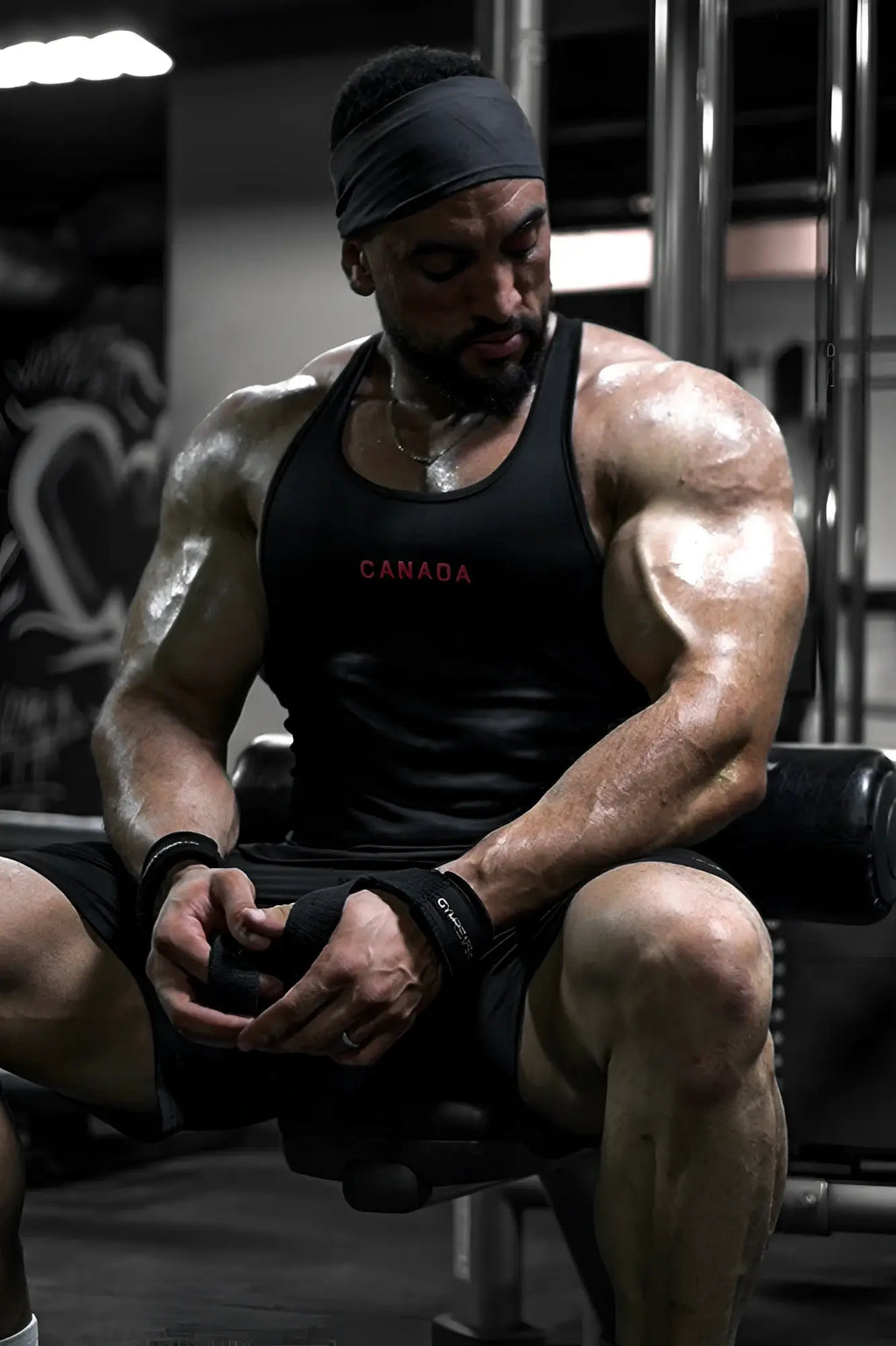Black fast-dry bodybuilding workout stringer tank top with canada printed in red across the chest