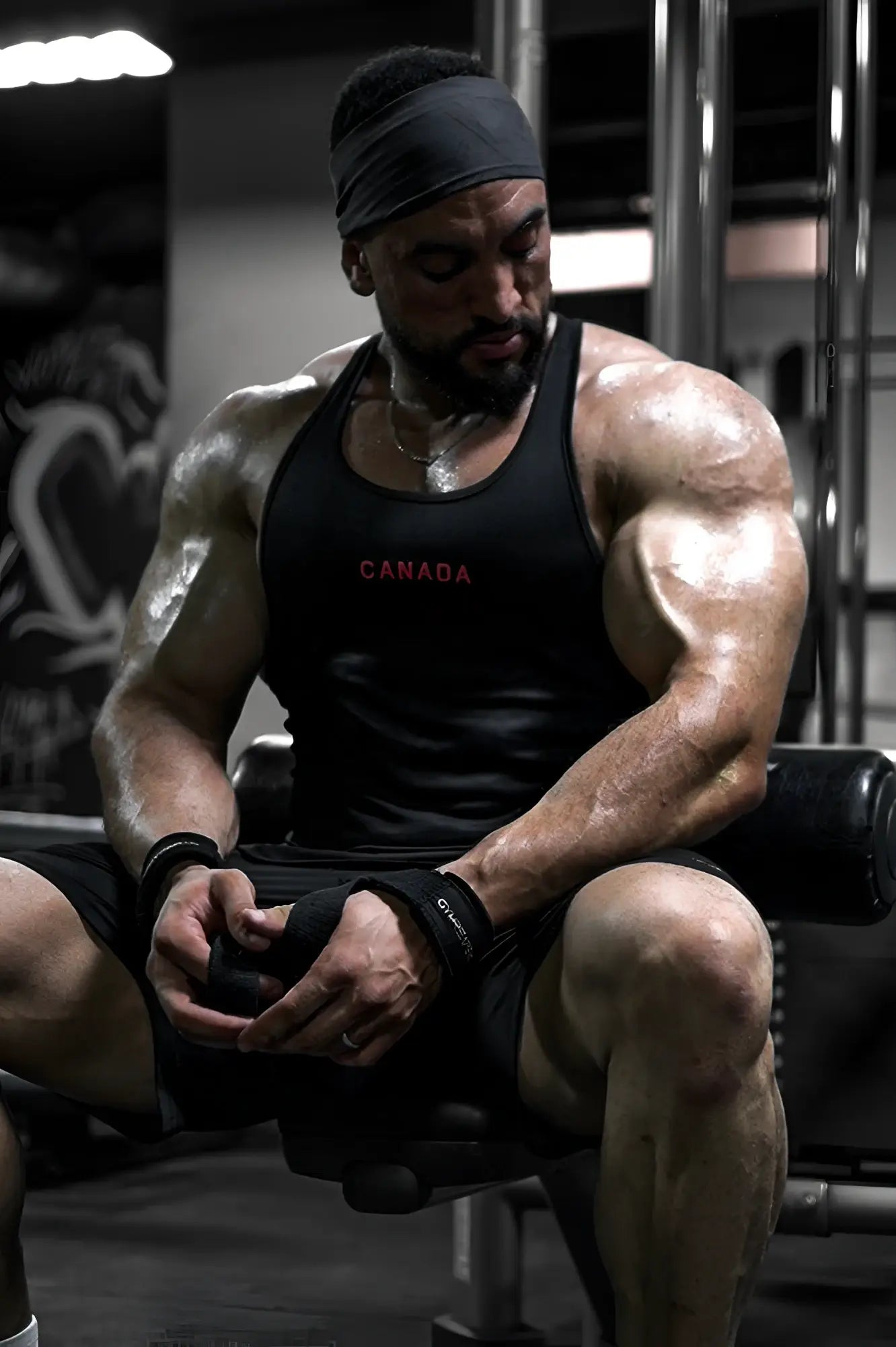 Black fast-dry bodybuilding workout stringer tank top with canada printed in red across the chest
