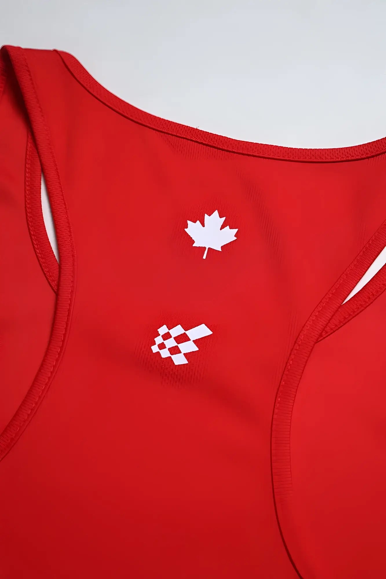 Red fast-dry bodybuilding workout stringer tank top with white maple leaf and checkered flag logo for intense training