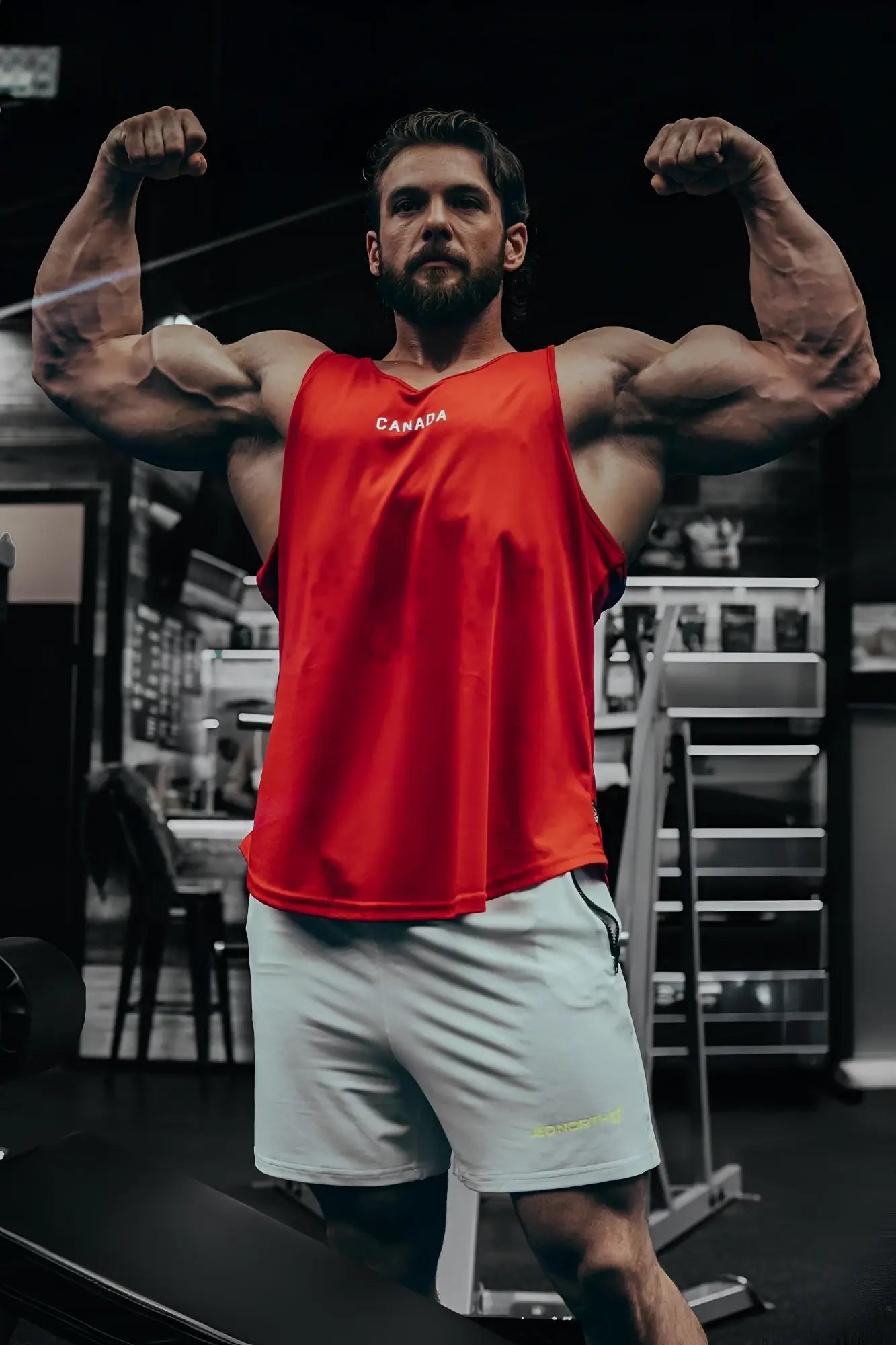 Red sleeveless fast-dry bodybuilding workout tank top with canada printed in white on the chest designed for training