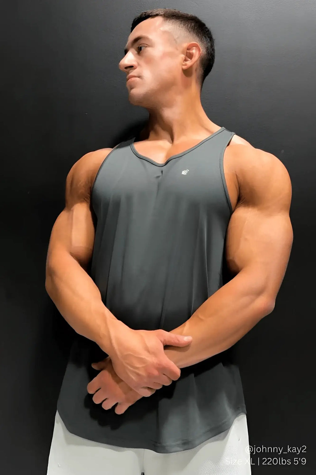 A dark gray jed north fast-dry bodybuilding workout stringer tank top with a subtle v-neck and small left chest logo