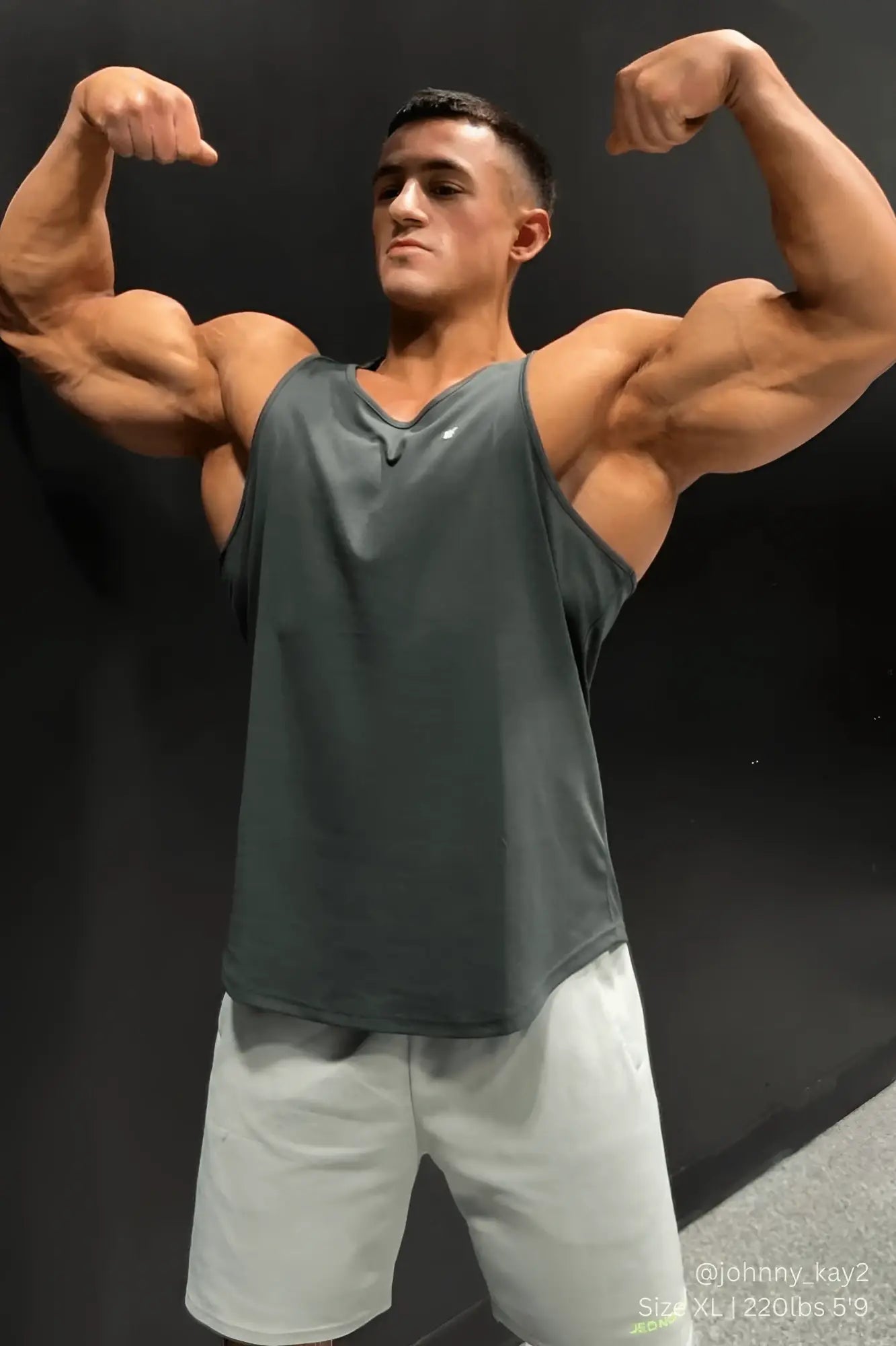 A dark gray sleeveless charcoal jed north fast dry bodybuilding workout stringer with v neckline and subtle logo