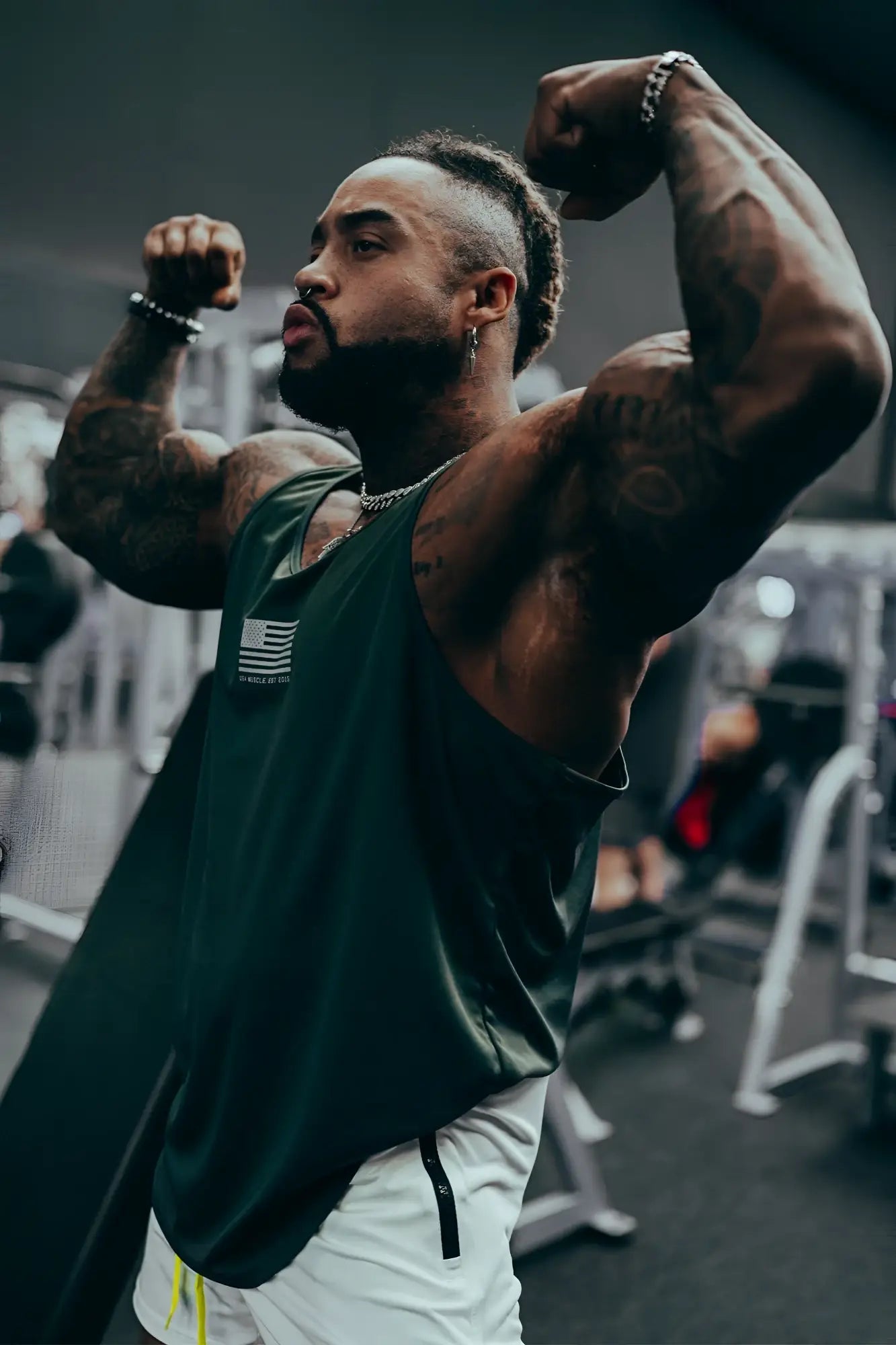 Dark green sleeveless fast-dry bodybuilding workout stringer tank top with small white american flag logo on chest
