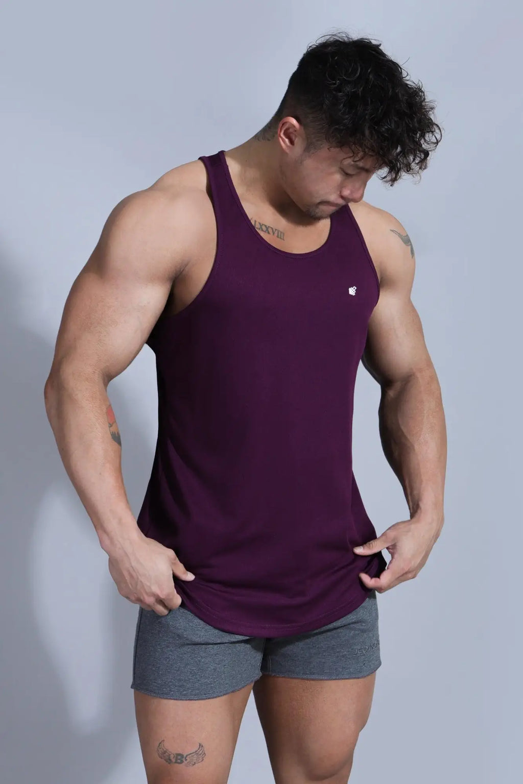 Jed North Fast-Dry bodybuilding workout stringer tank top in dark purple with a small white logo on the chest