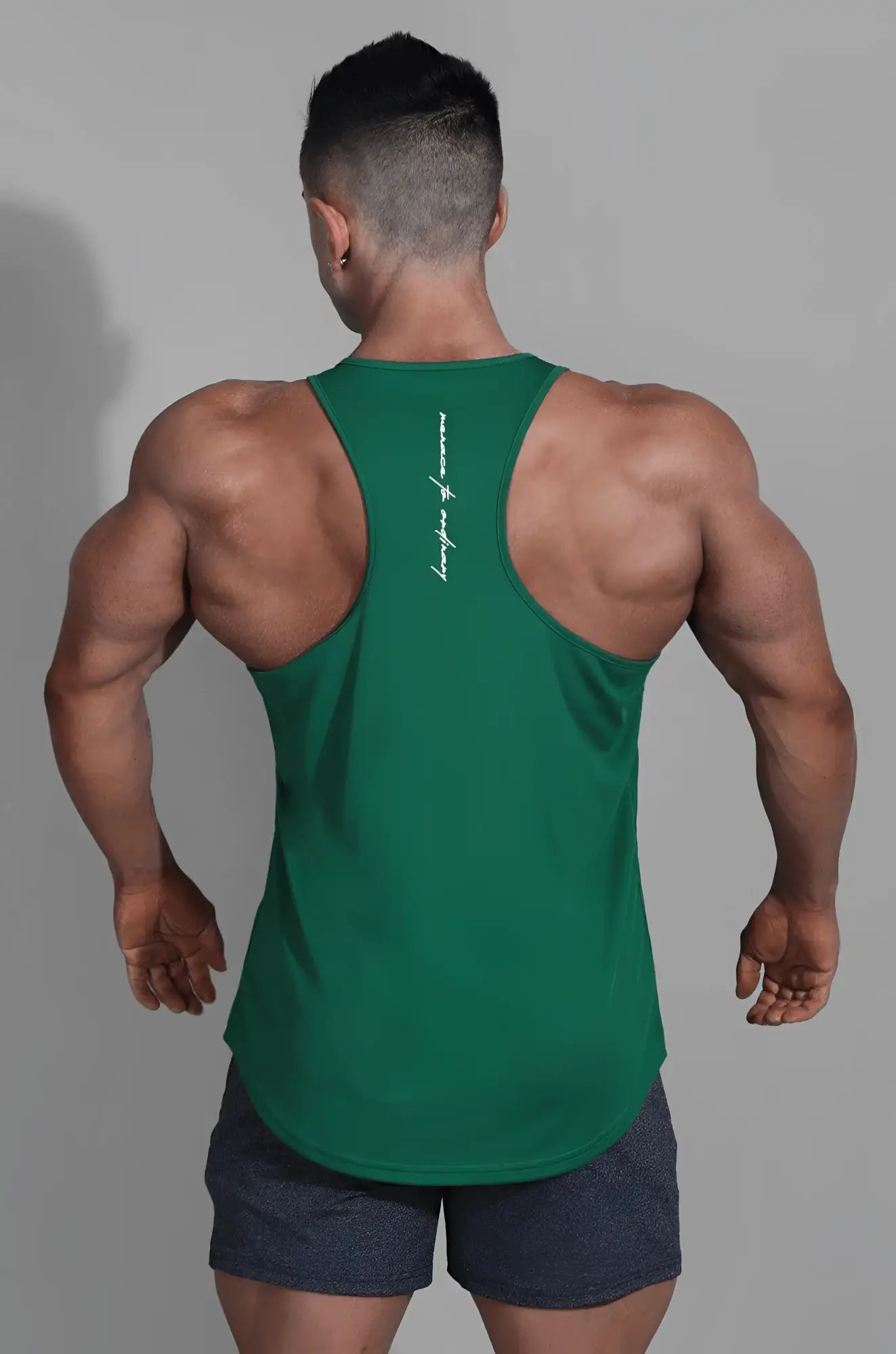 Back view of jed north fast-dry bodybuilding workout stringer tank top in emerald with white vertical script design