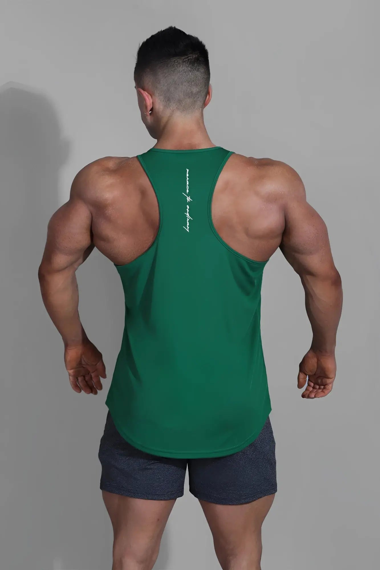 Back of an emerald green jed north fast-dry bodybuilding workout stringer muscle tank with white script logo