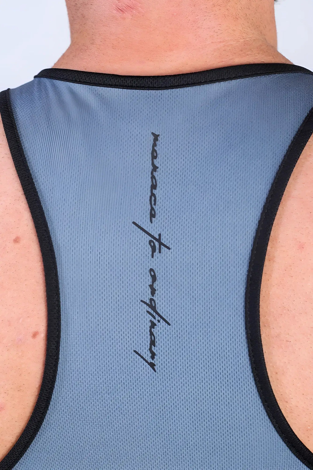 Back of jed north fast-dry bodybuilding workout stringer in blue mesh with black trim and monaco of ordinary logo