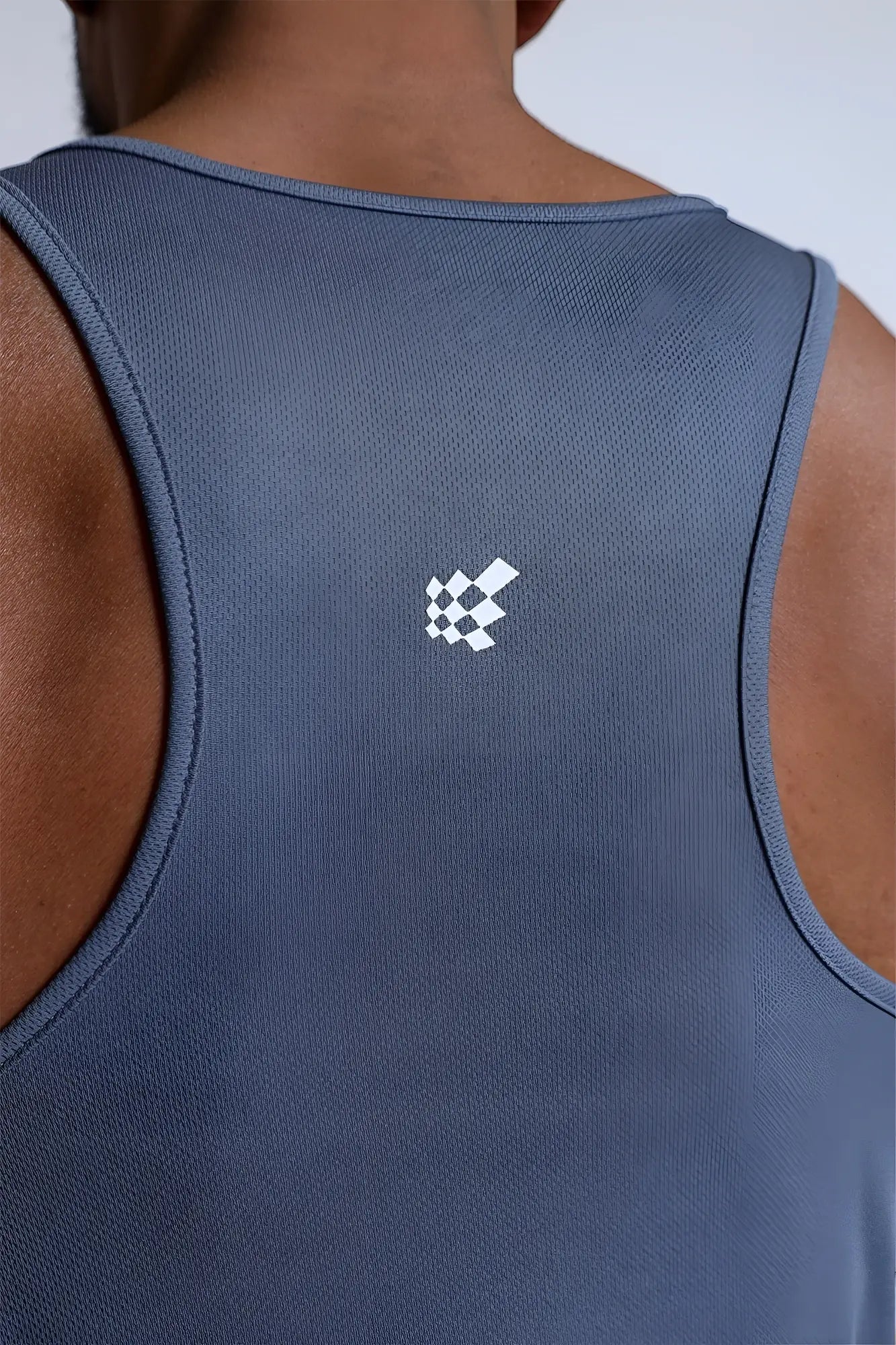 Back of a navy blue fast-dry bodybuilding workout stringer tank top with subtle texture and a gray usa logo