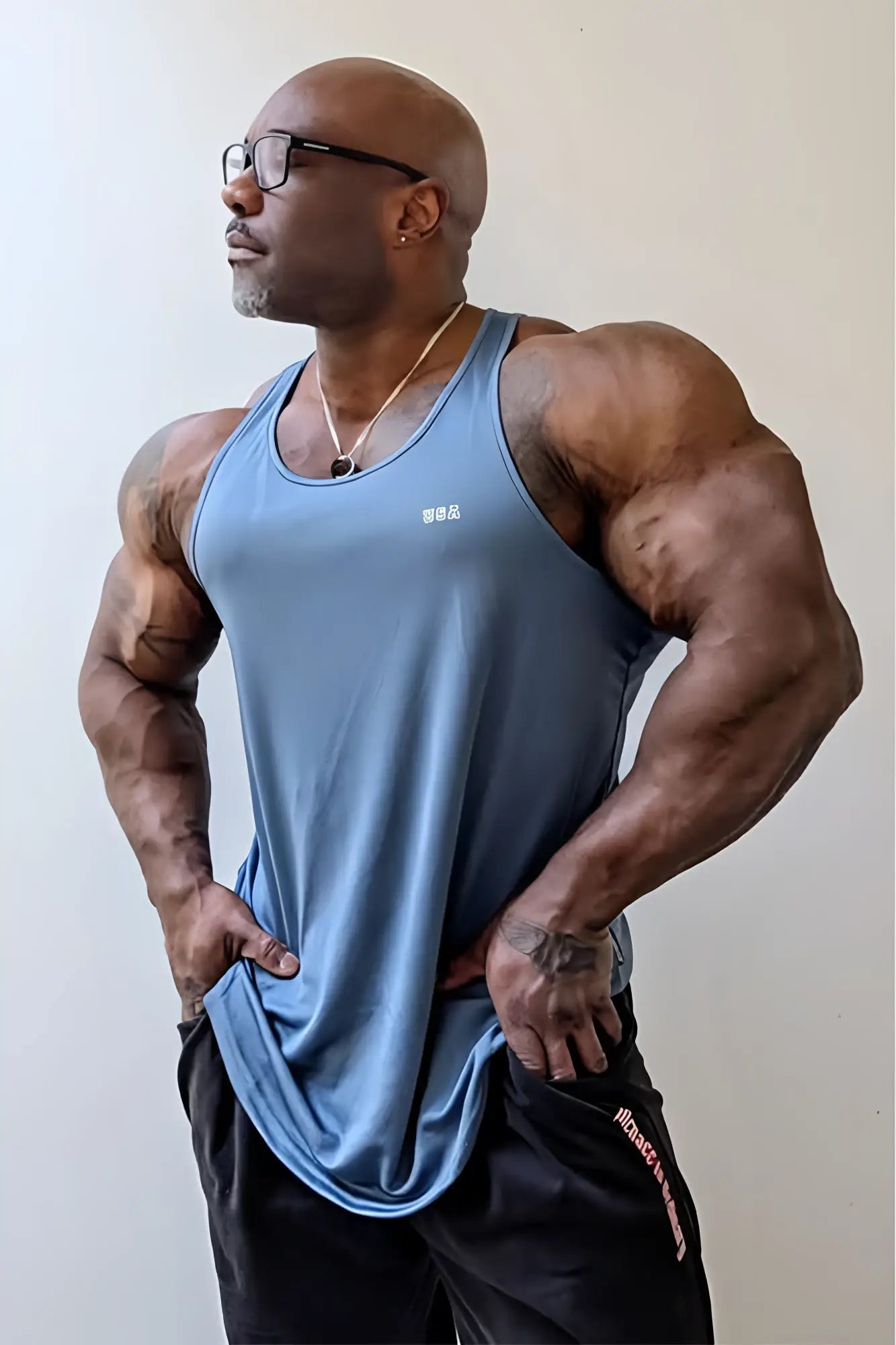 A sleek light blue fast-dry bodybuilding workout stringer tank top with a subtle gray usa logo on the chest