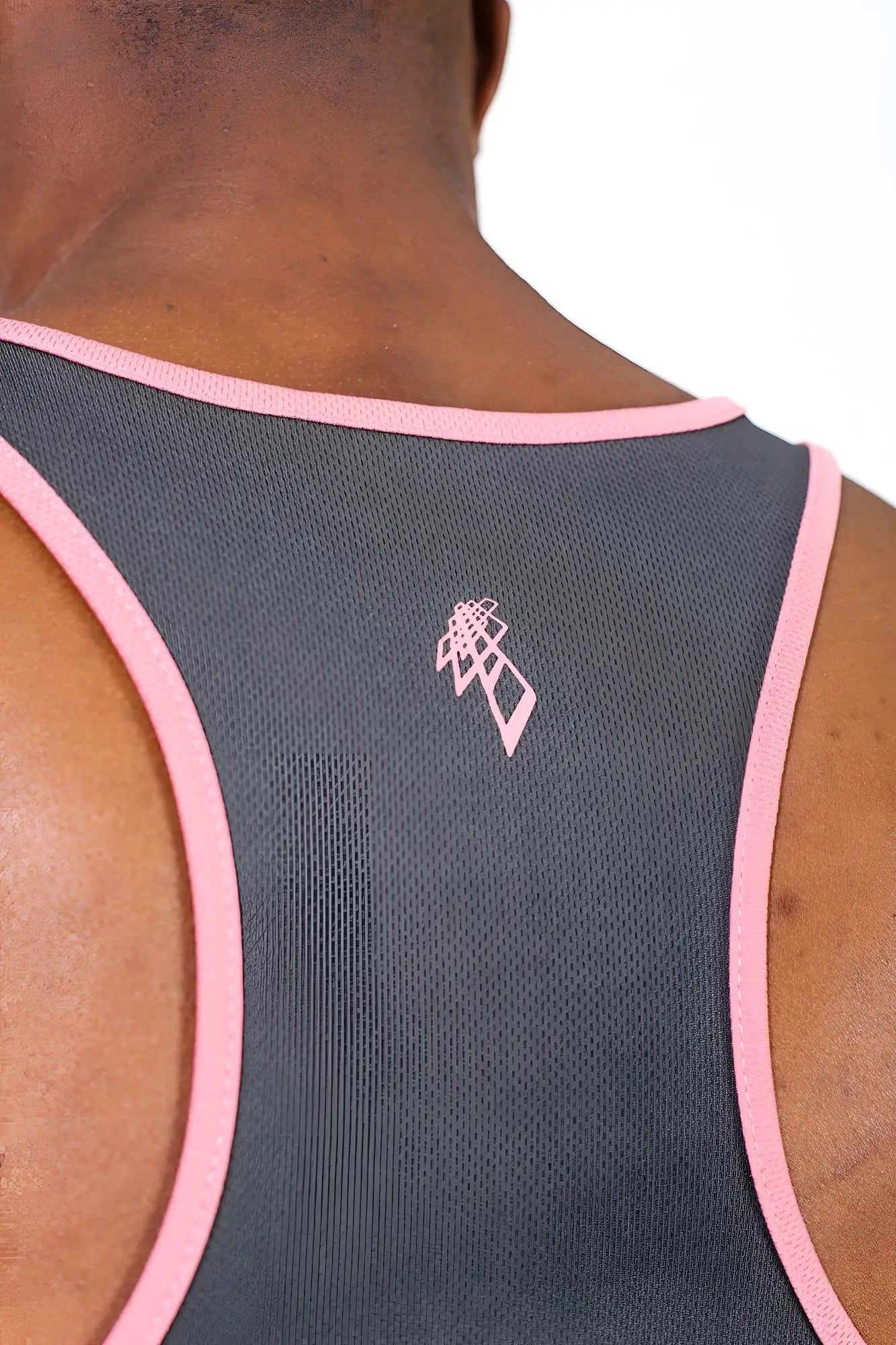Back view of a gray fast-dry bodybuilding workout stringer tank top with pink trim and a small pink logo
