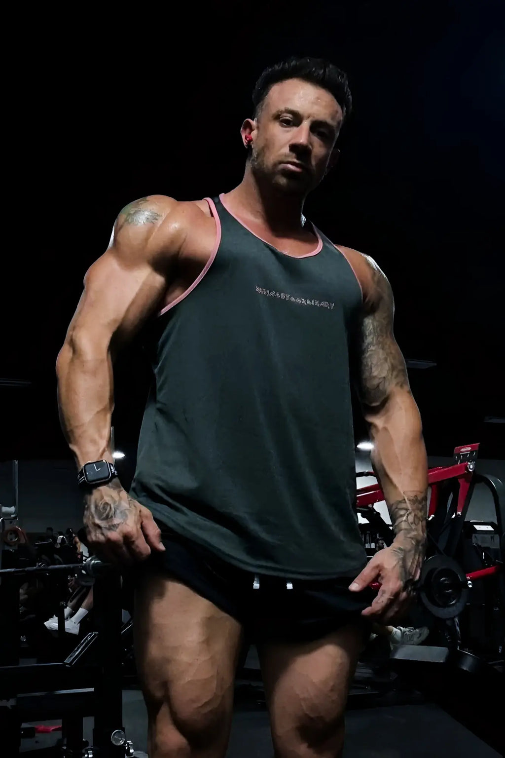Dark green fast-dry bodybuilding workout stringer tank top with pink trim and small white chest logo