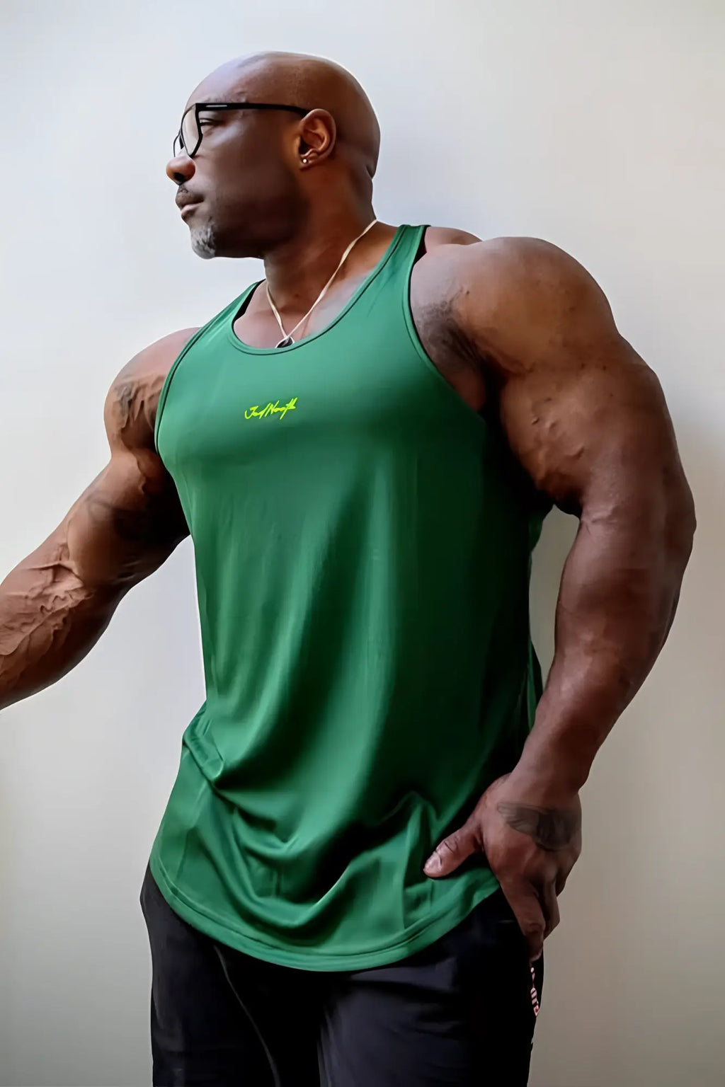 Green fast-dry bodybuilding workout stringer tank top with neon yellow logo on chest for athletic use