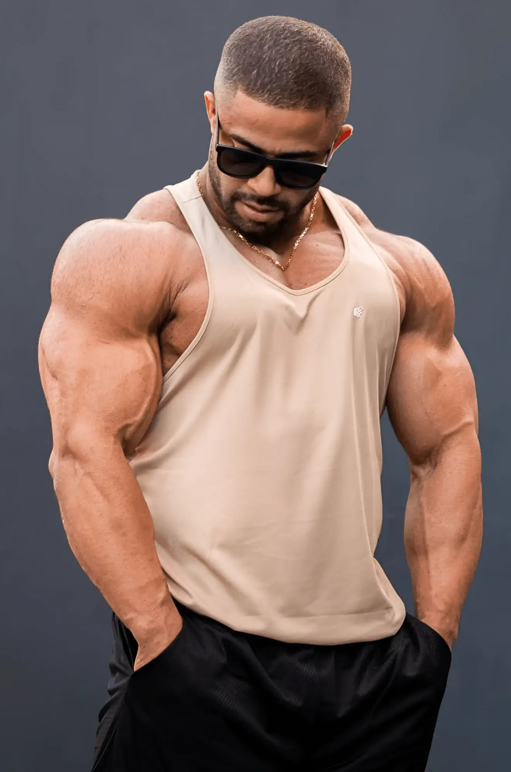Beige sleeveless jed north fast dry bodybuilding workout stringer tank top with subtle chest logo in khaki color