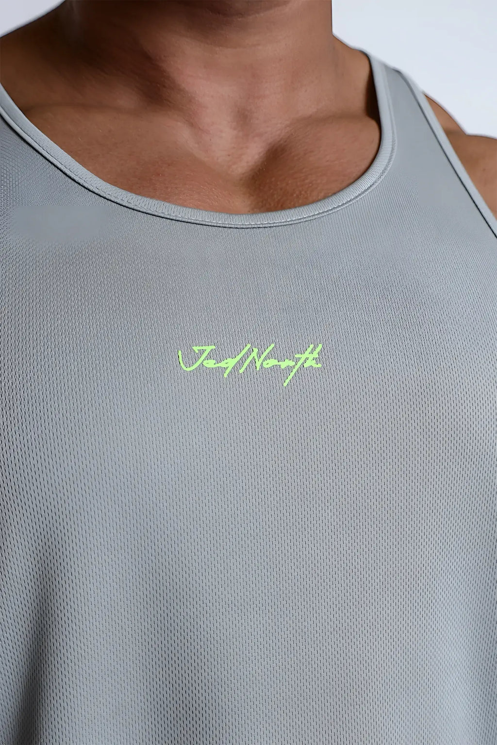 Gray fast-dry bodybuilding workout stringer with neon green jednorth embroidery on chest for athletic use