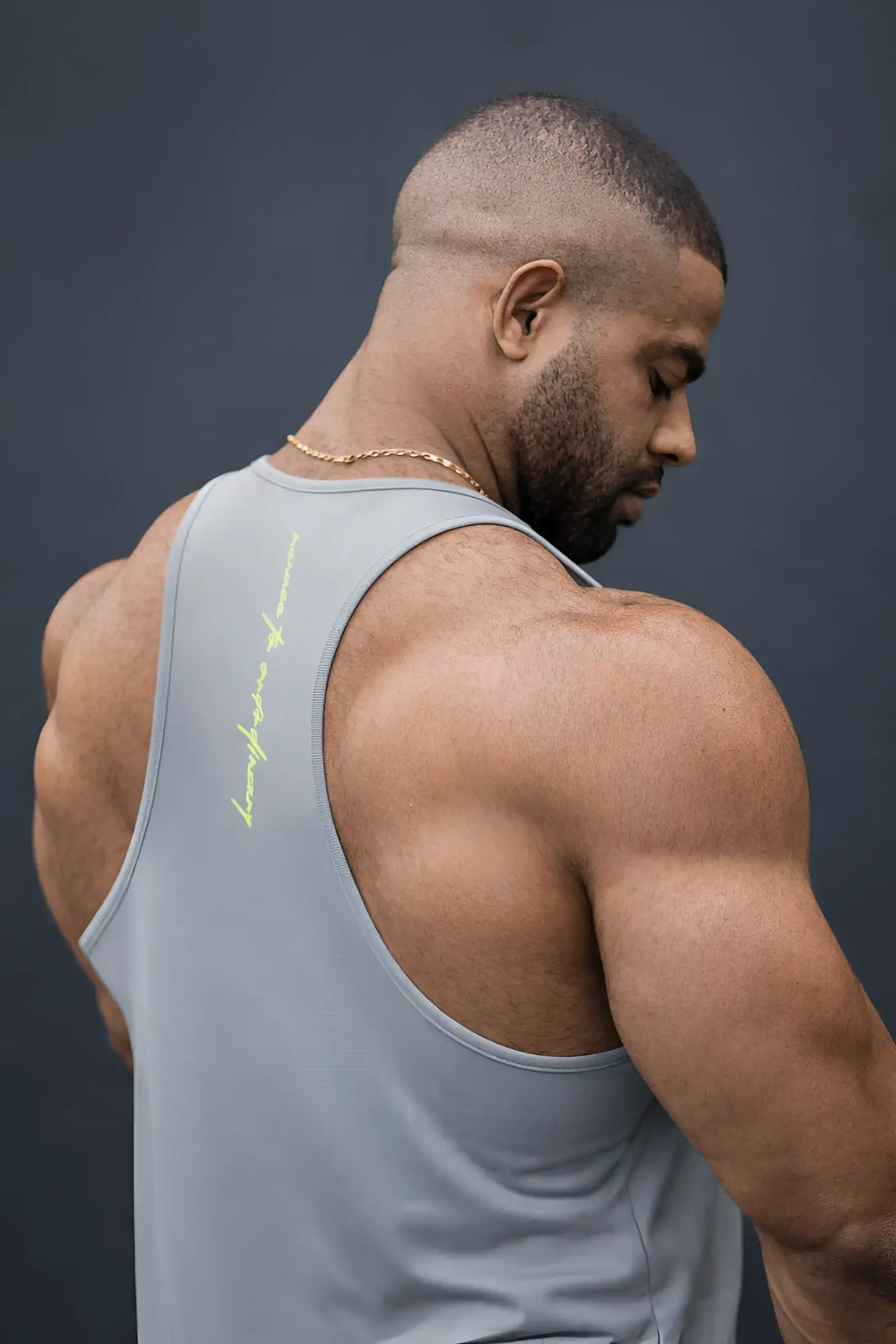 Light gray fast-dry bodybuilding workout stringer tank top with a subtle neon yellow logo on the left shoulder