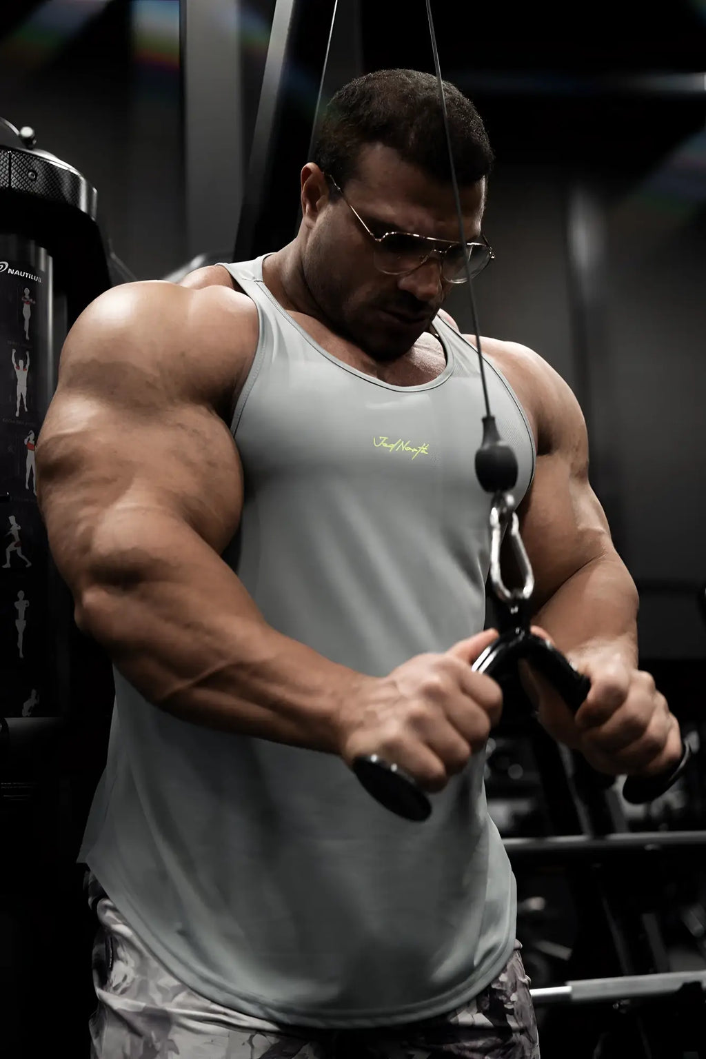 A light gray fast-dry bodybuilding workout stringer tank top with a small gold embroidered logo on the chest