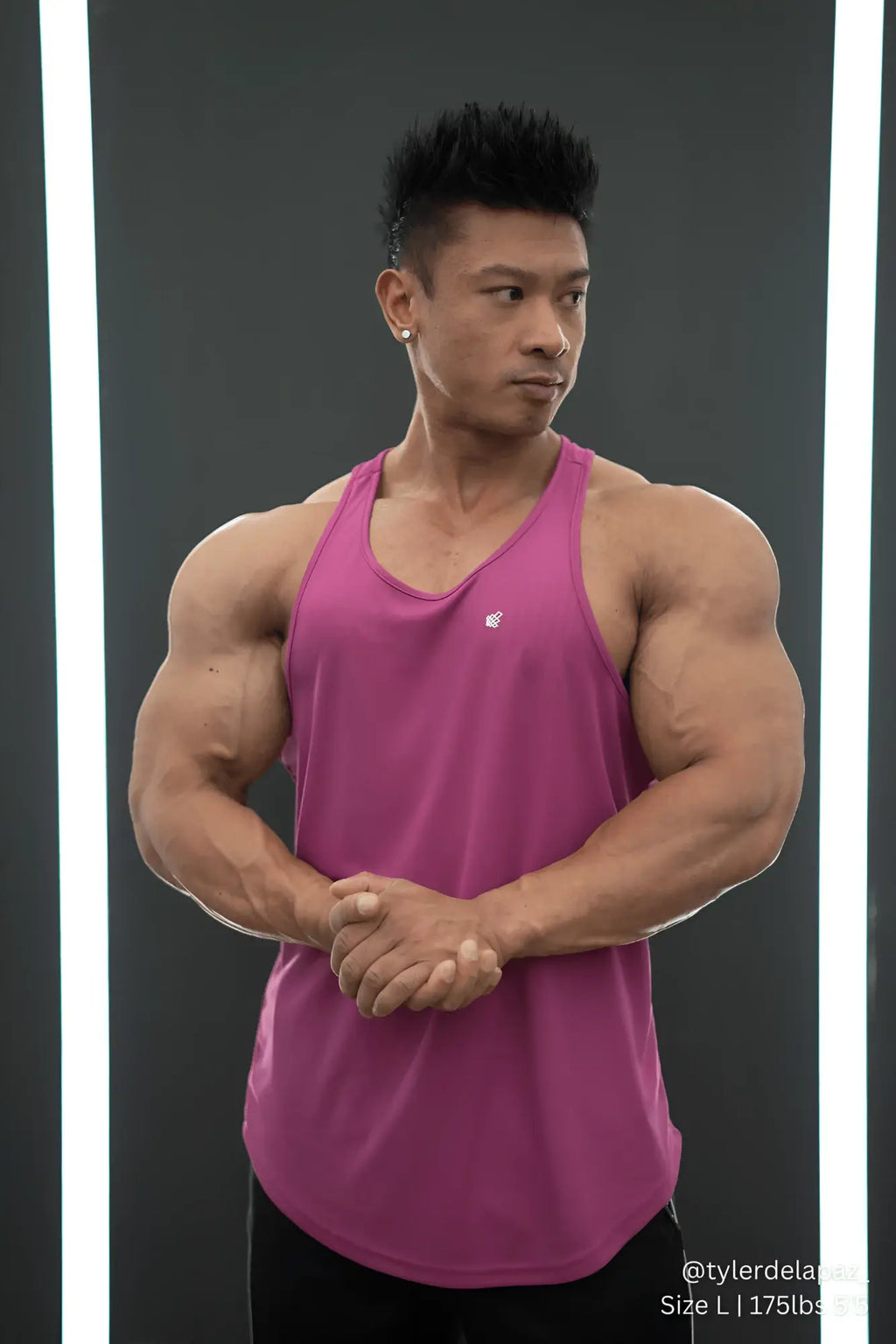 A vibrant magenta fast-dry bodybuilding workout stringer tank top with scoop neckline and subtle chest logo