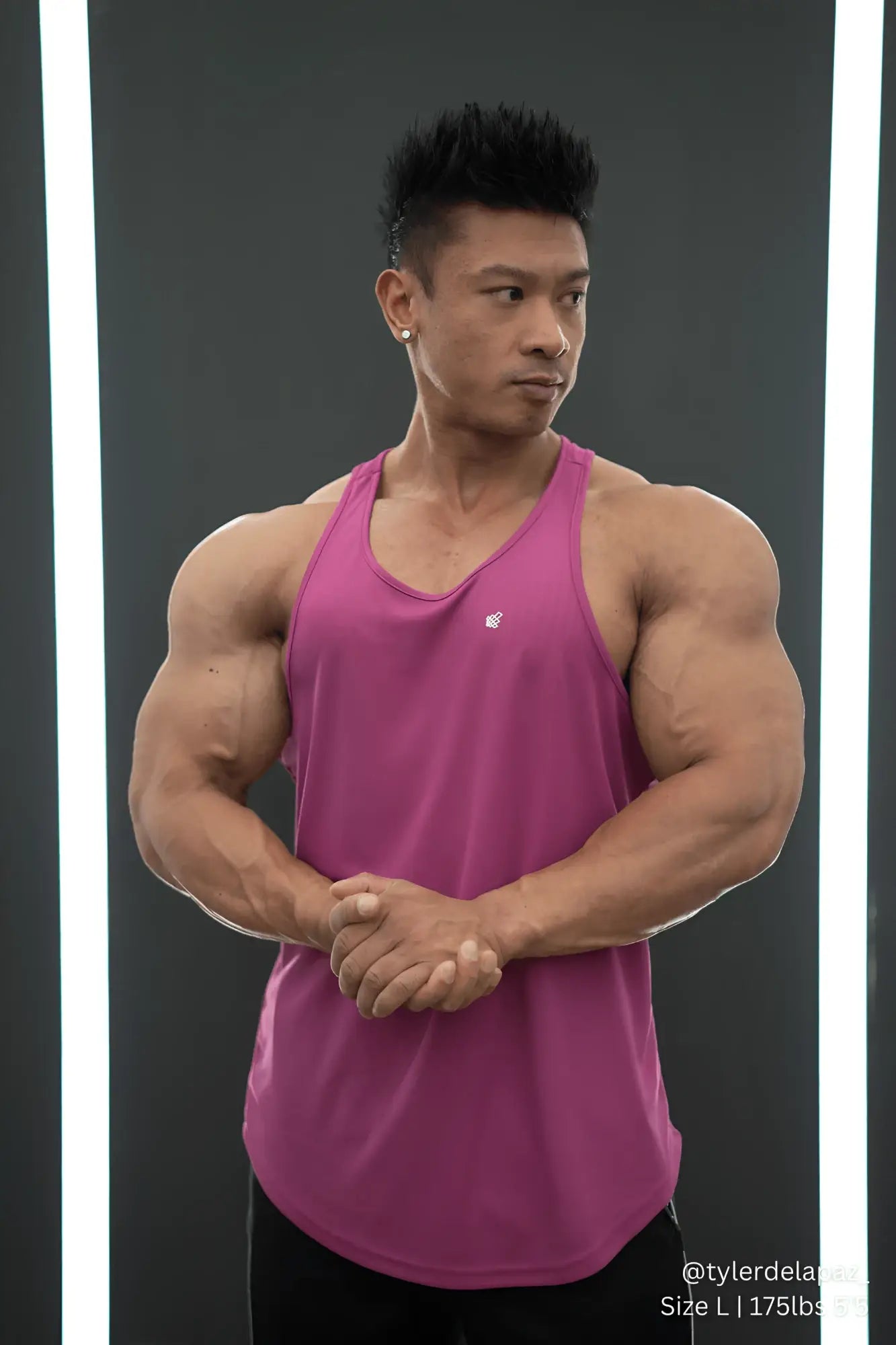 A vibrant magenta fast-dry bodybuilding workout stringer tank top with scoop neckline and subtle chest logo