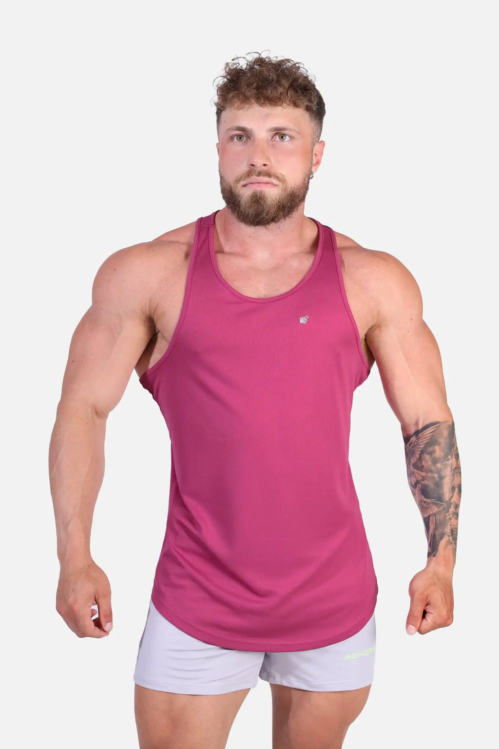 A vibrant magenta sleeveless fast-dry bodybuilding workout stringer with a subtle logo on the upper left chest