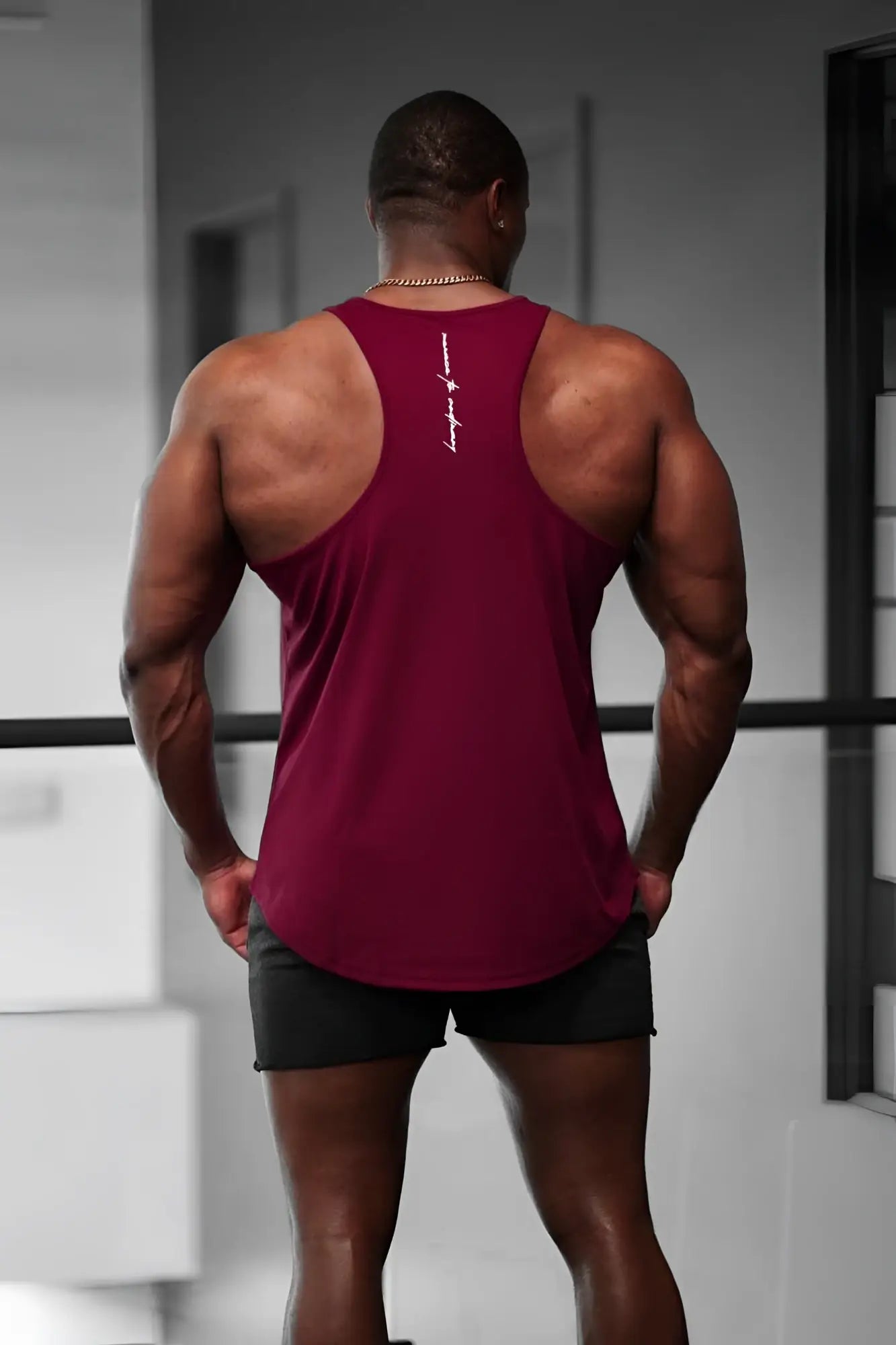 Back view of jed north maroon fast-dry bodybuilding workout stringer with white vertical stitch detail