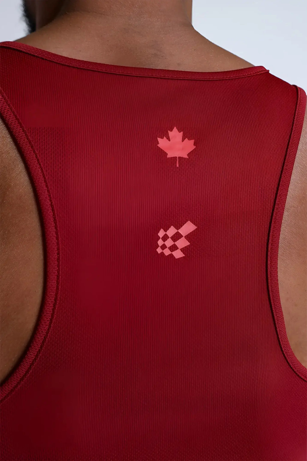 Back view of maroon fast-dry bodybuilding workout stringer with pink maple leaf and checkered flag emblem