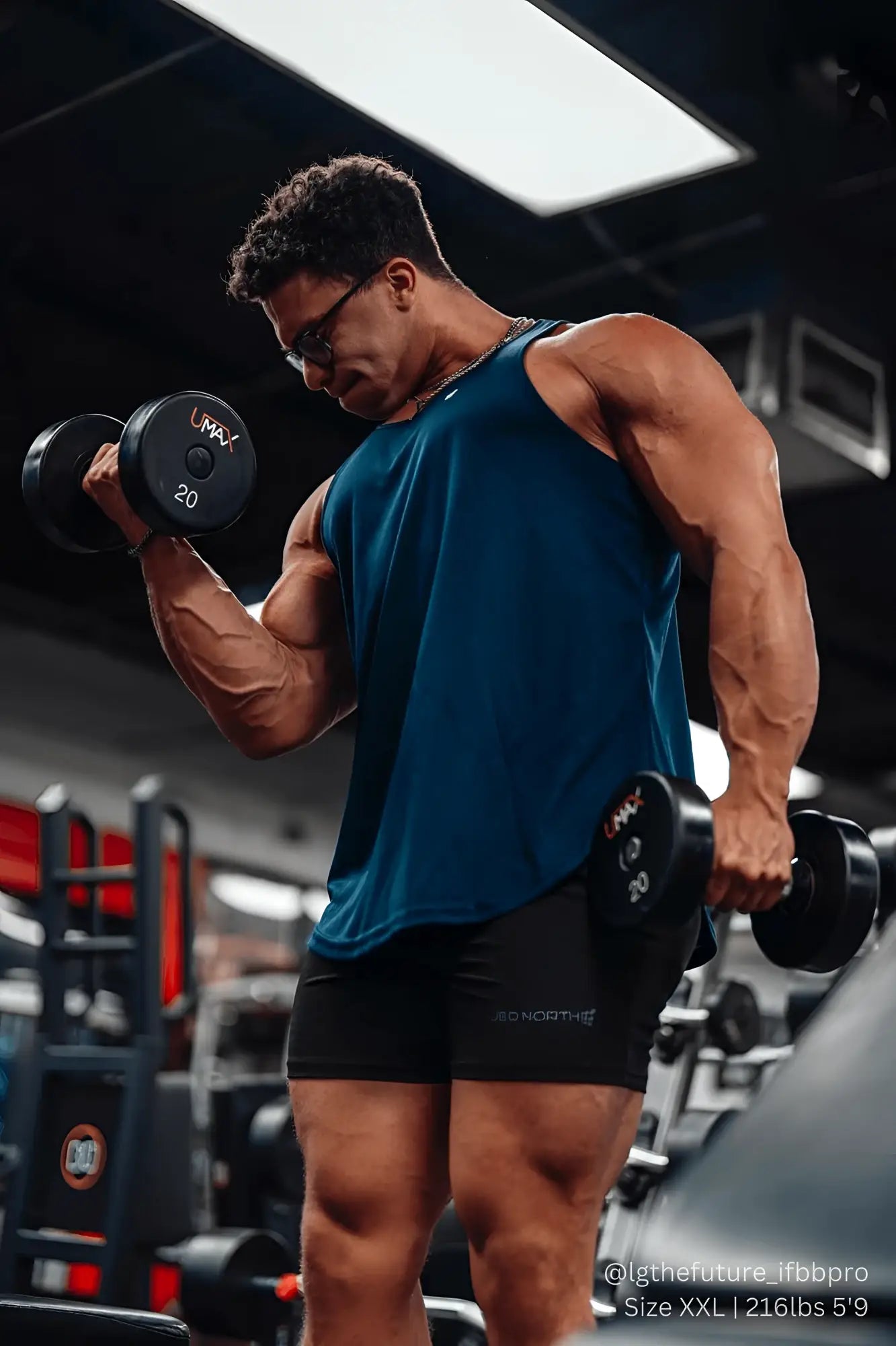 Black umax 20-pound matte dumbbell with bold white branding alongside jed north navy fast-dry bodybuilding stringer
