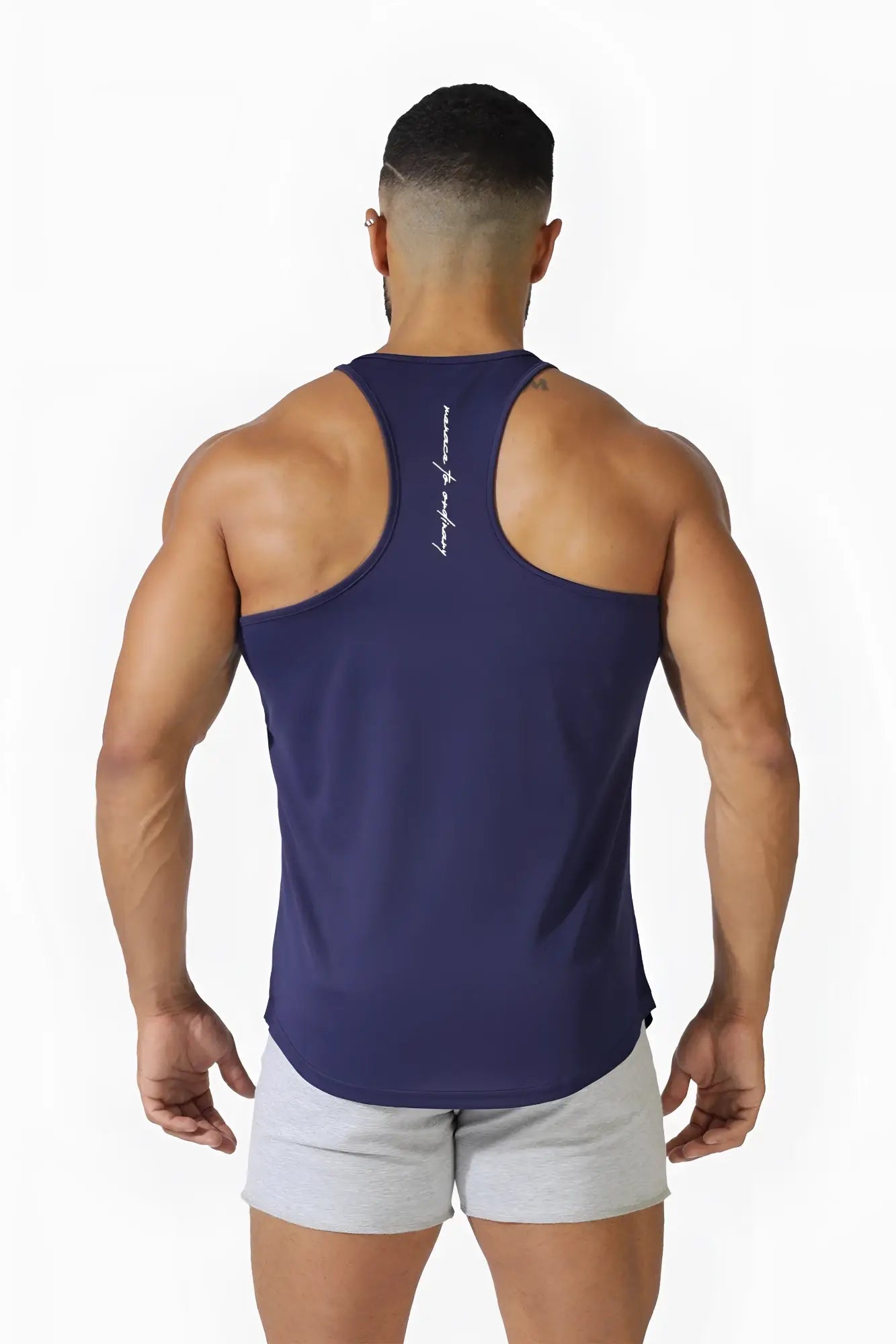 Back view of jed north navy blue fast-dry bodybuilding workout stringer tank top with white cursive lettering down spine