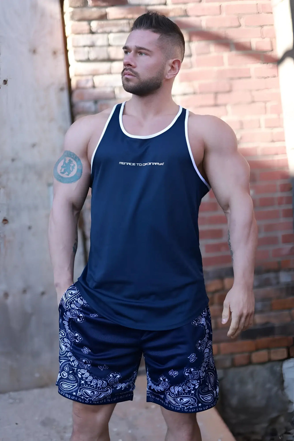 Navy blue fast-dry bodybuilding workout stringer tank top with white trim and small logo on chest