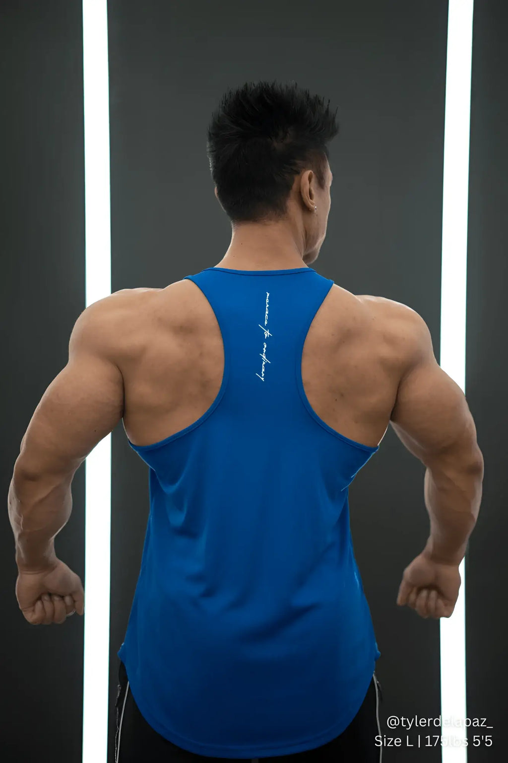 Back view of royal blue fast-dry bodybuilding workout stringer tank top with white vertical lettering