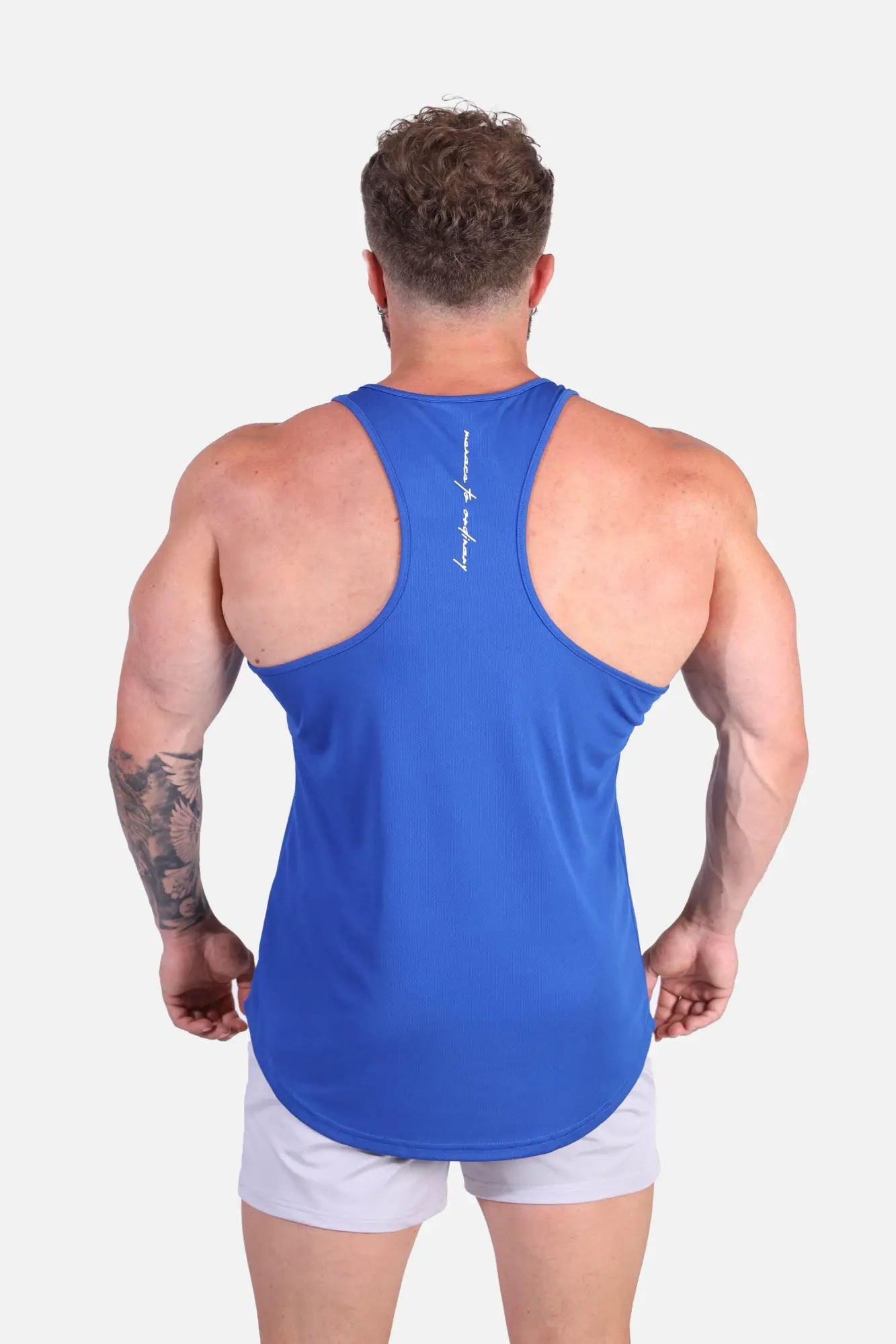 Back view of royal blue fast-dry bodybuilding workout stringer tank top with subtle white script logo on center back