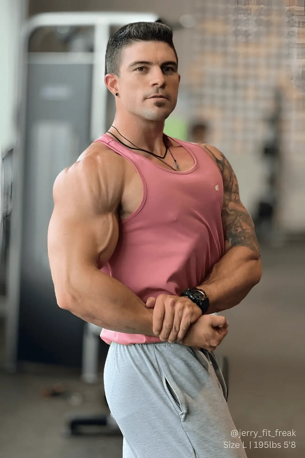 A salmon pink sleeveless fast-dry bodybuilding workout tank top with a small jed north logo on the chest