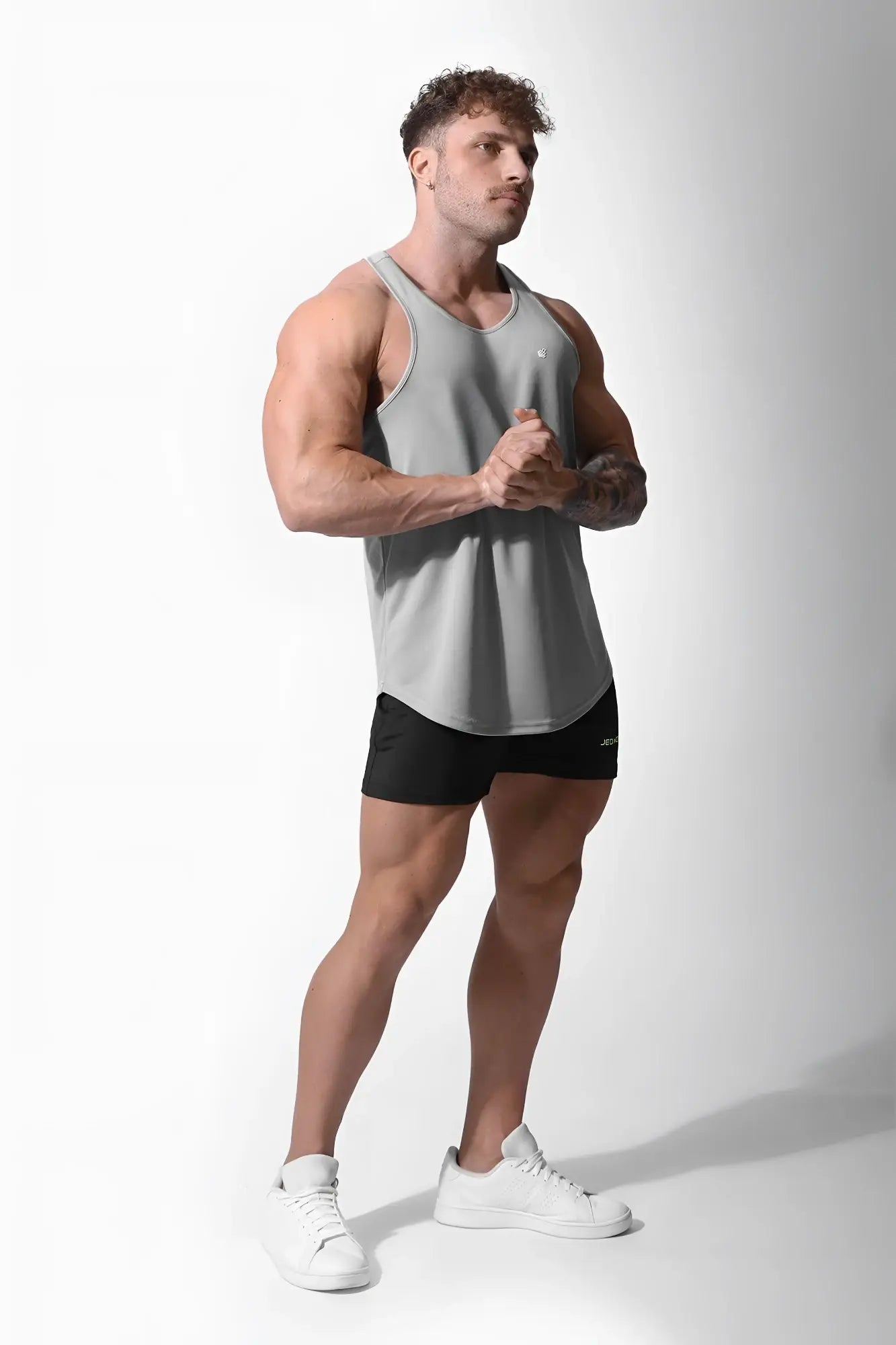 Gray jed north fast dry bodybuilding workout stringer tank top with subtle chest logo for athletic use
